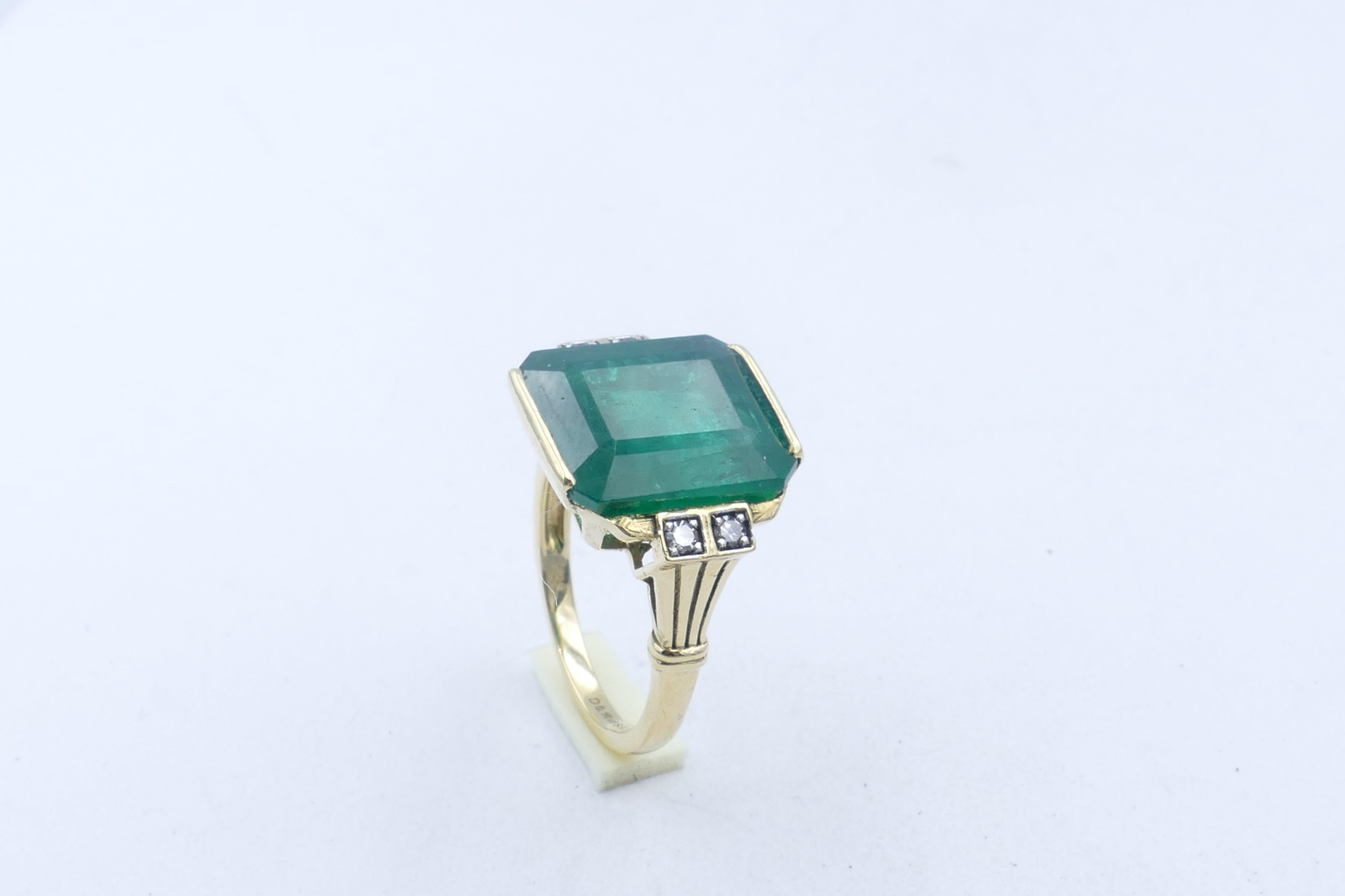 Stunning strong colour Emerald Stone, dimensions 13.35mm X 11.82mm X 7mm forms the centrepiece of this beautiful, classic Ring.
The Emerald is embellished with with 4 bead set natural single cut Diamonds, colour G, Clarity VS2 - SI2.
Total Gemstone