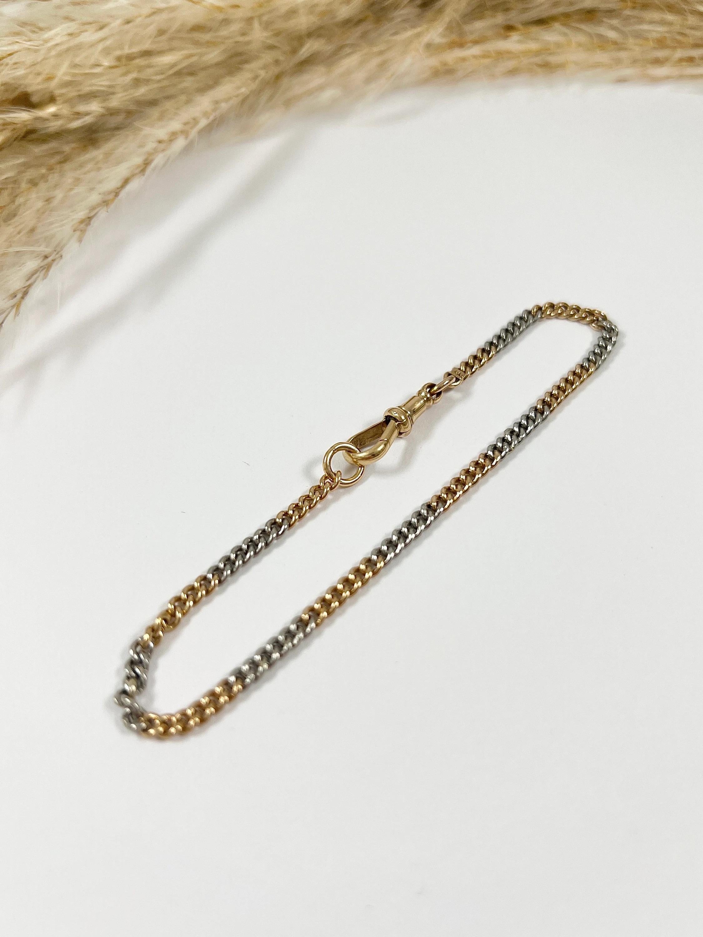 Antique Curb Bracelet 

18ct Gold Stamped 

Circa 1920s

Makers Mark W H W Ltd

This 1920s gold and platinum curb bracelet is a true testament to the craftsmanship and artistry of the era, blending the warmth of gold with the cool elegance of