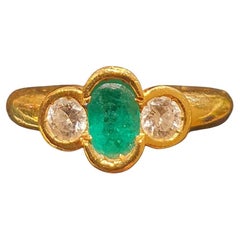 Bague en or jaune 18 carats sertie d'une émeraude entourée de 2 diamants