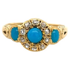 Ring aus 18 Karat Gelbgold mit türkisfarbenen Diamanten auf dem Halo