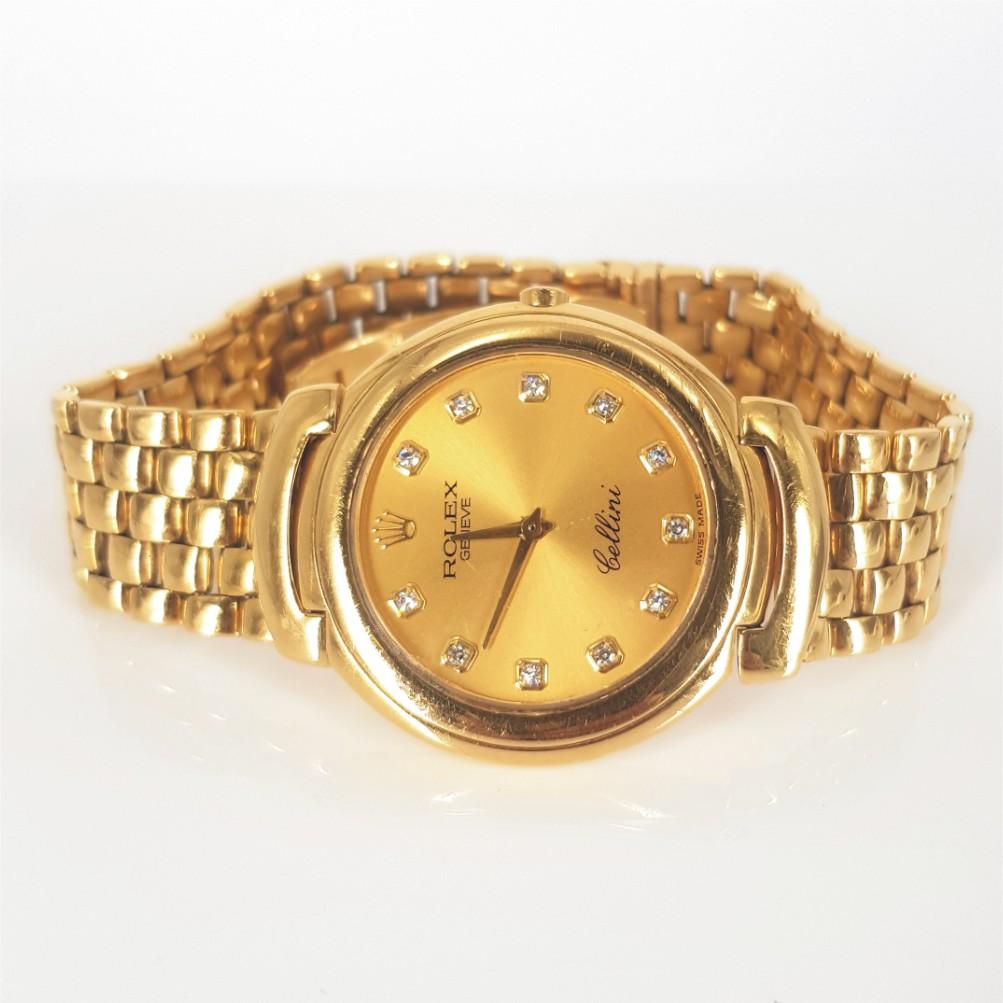 18ct Gelbgold Rolex Cellini Uhr - Quarz in gutem Zustand. 
Modellnummer: E652182 & Seriennummer: 6623/8
Gehäuse aus 18 kt Gelbgold (37 mm inkl. Krone) mit 11 Diamanten mit einem Gewicht von je 0,01 Karat in FG vs Qualität. Gold & Diamant-Zifferblatt