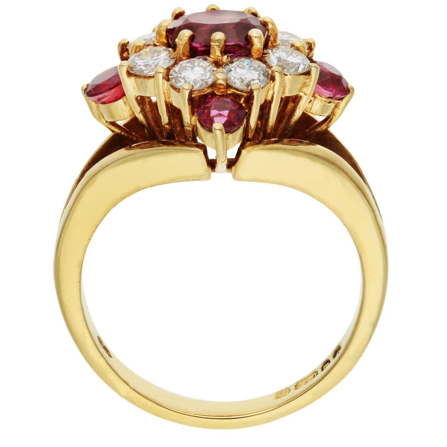 Elevate your style with our Pre-Loved 18ct Yellow Gold Ruby & Diamond Ring, a dazzling cluster of vibrant gemstones and exquisite design. At its heart, an alluring oval ruby takes centre stage, enveloped by a halo of round brilliant-cut diamonds,