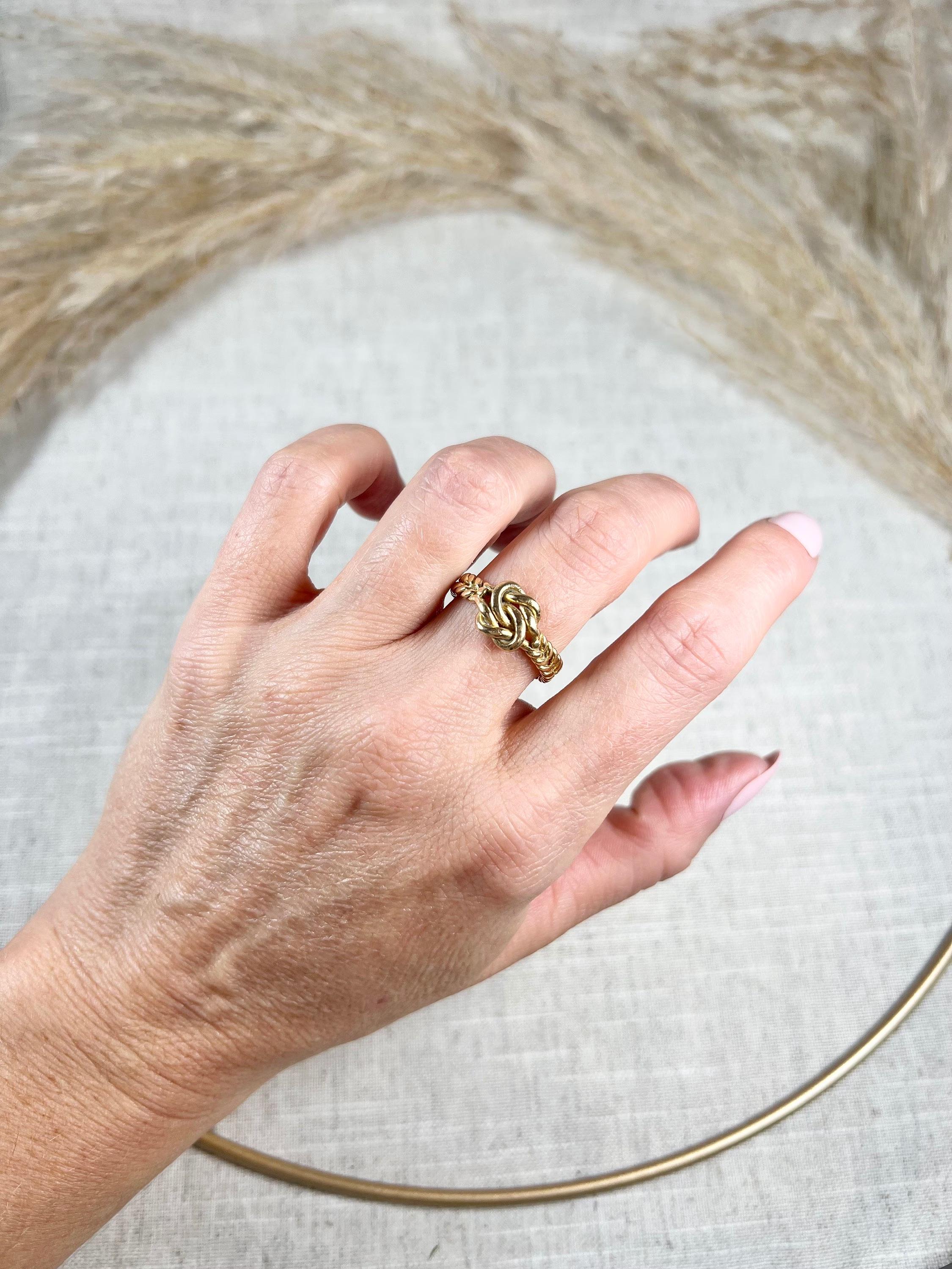 Antique Knot Ring 

18ct Gold Tagged

Circa 1900

This exquisite Edwardian lovers knot ring is made of 18ct gold and features a beautifully crafted plaited/braided gold band. The intricate design of the band creates an elegant and timeless look,