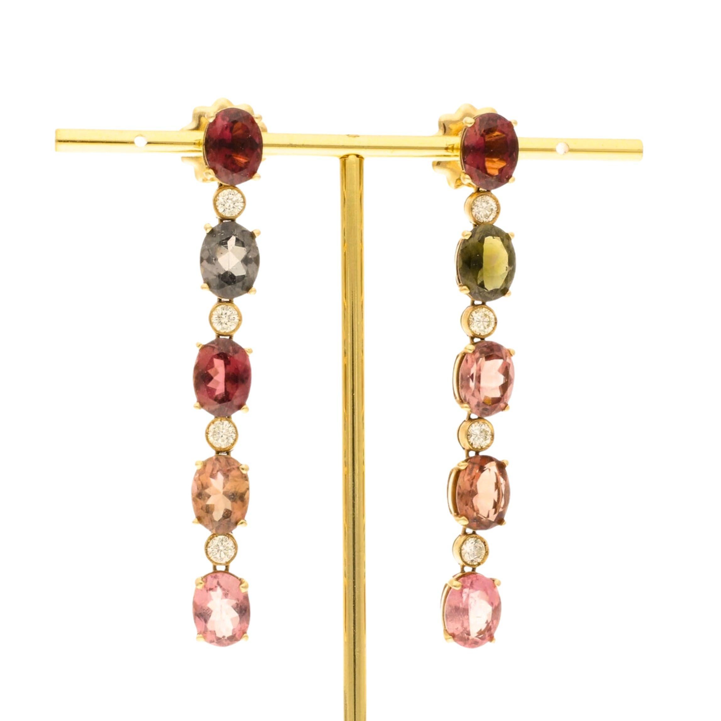 Elevate your elegance with our Pair of Pre-Loved 18ct Yellow Gold Tourmaline & Diamond Drop Earrings, a mesmerising cascade of vibrant colours and scintillating diamonds. Each earring features a delightful arrangement of five oval-cut, mixed-colour