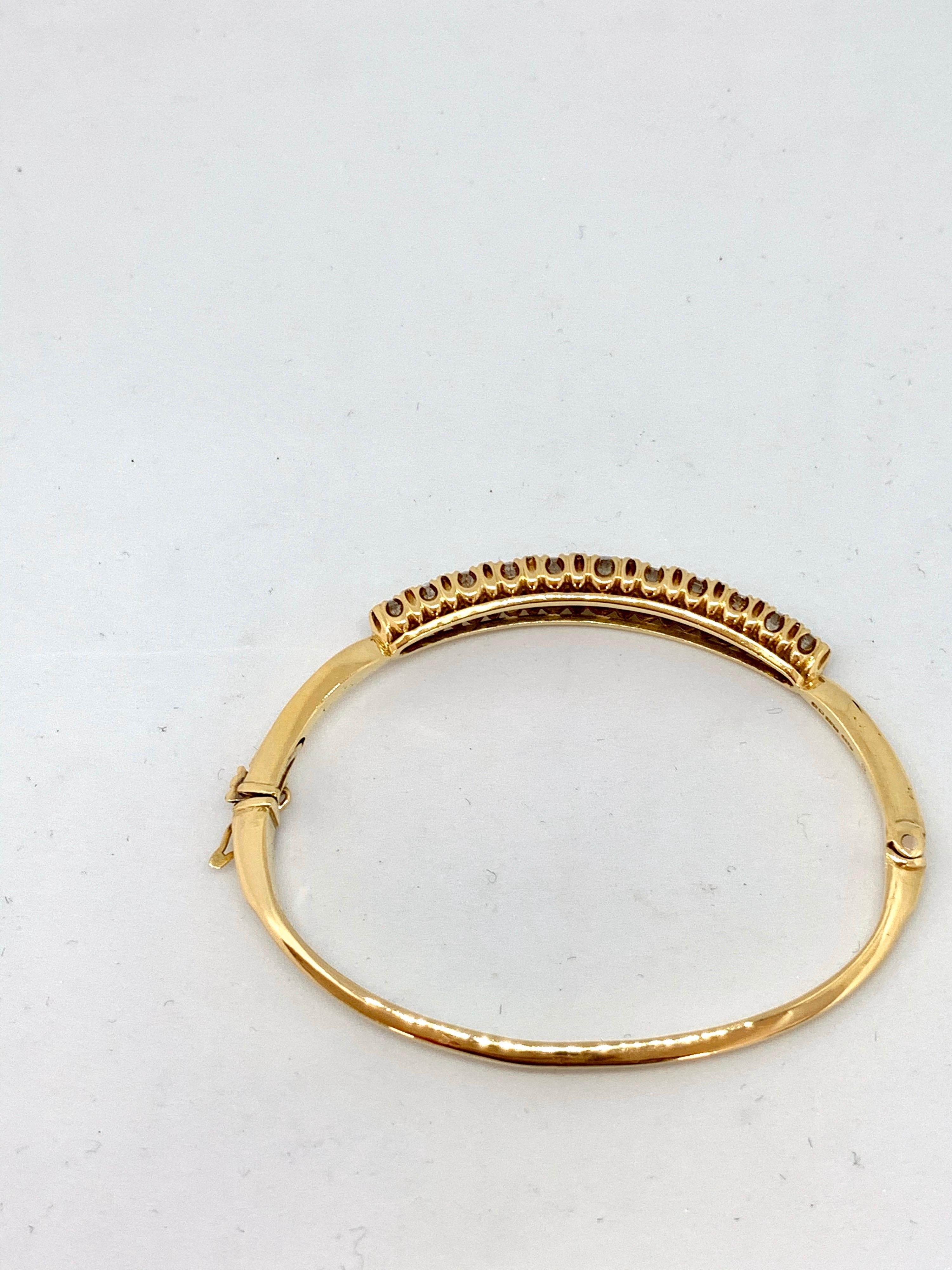 18ct yellow gold Victorian style hinged diamond set bangle. 1974 London assay mark J&P sponsor.
Solid oval hinged bangle inside dimensions -60.0mm length x 46.0mm width
Centre graduated claw set diamond section45.0mm length x 7.50mm width in the