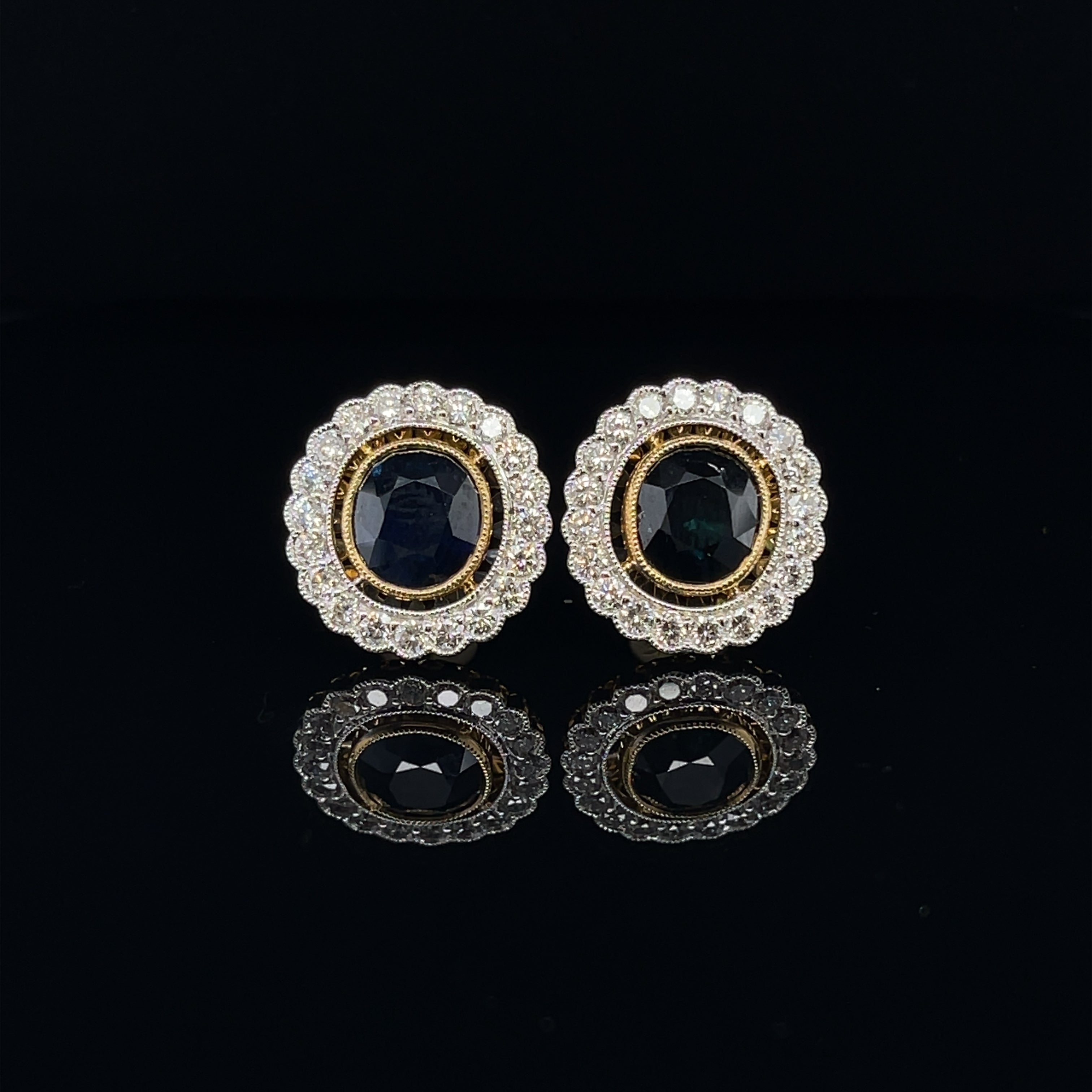 Burma oval cut blue sapphires, crafted with Eighteen Karat white and yellow gold, featuring a lovely selection of thirty six, round brilliant cut diamonds, complemented by a stunning polished finish design. 

Sapphire Weight: 3.85ct 
Sapphire