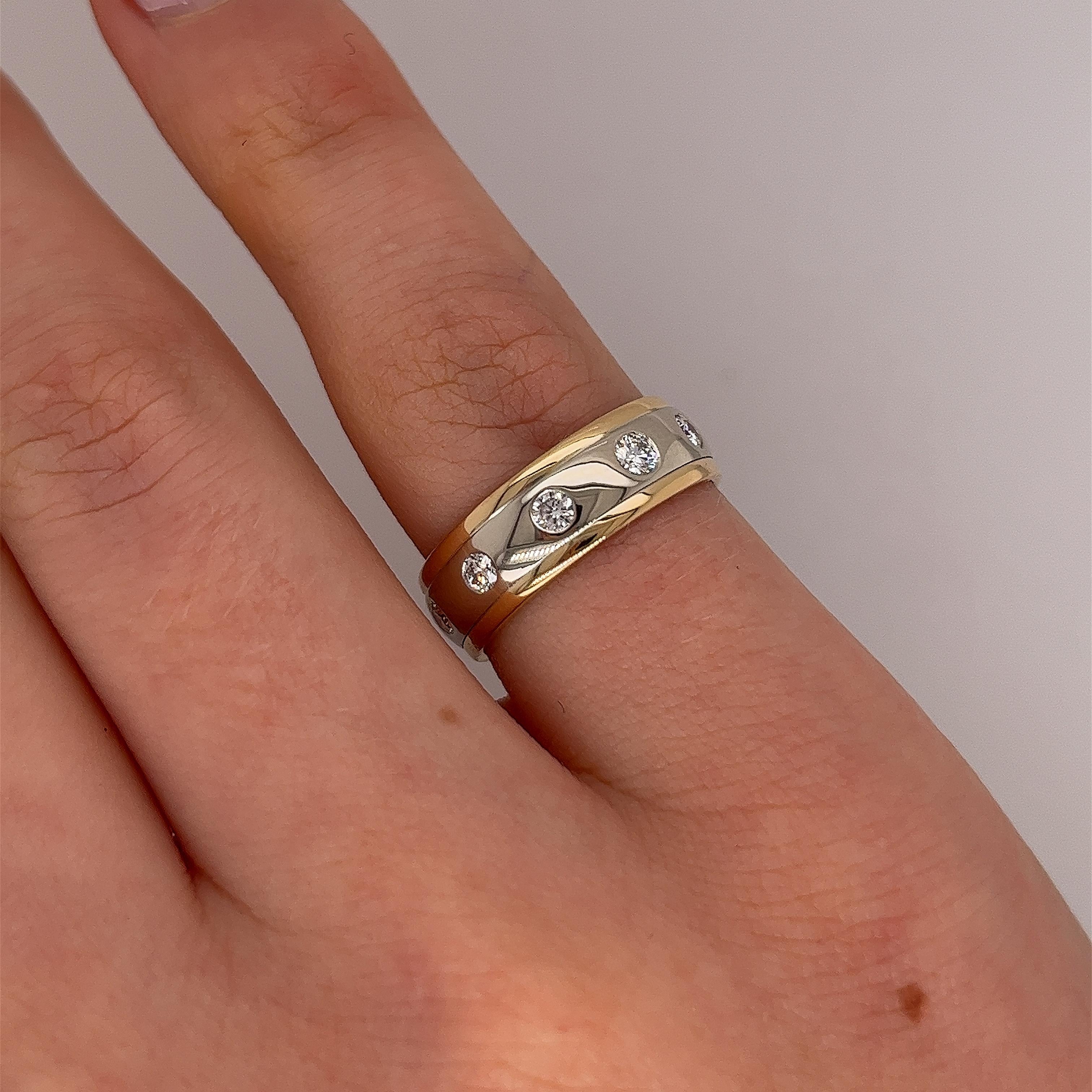 An elegant diamond band ring, set with 10 round brilliant cut natural diamonds, 0.35ct total diamond weight. In an 18ct yellow and white gold setting.

Total Diamond Weight: 0.35ct
Diamond Colour: G-H
Diamond Clarity: SI1
Width of Band: 5.92mm
Total
