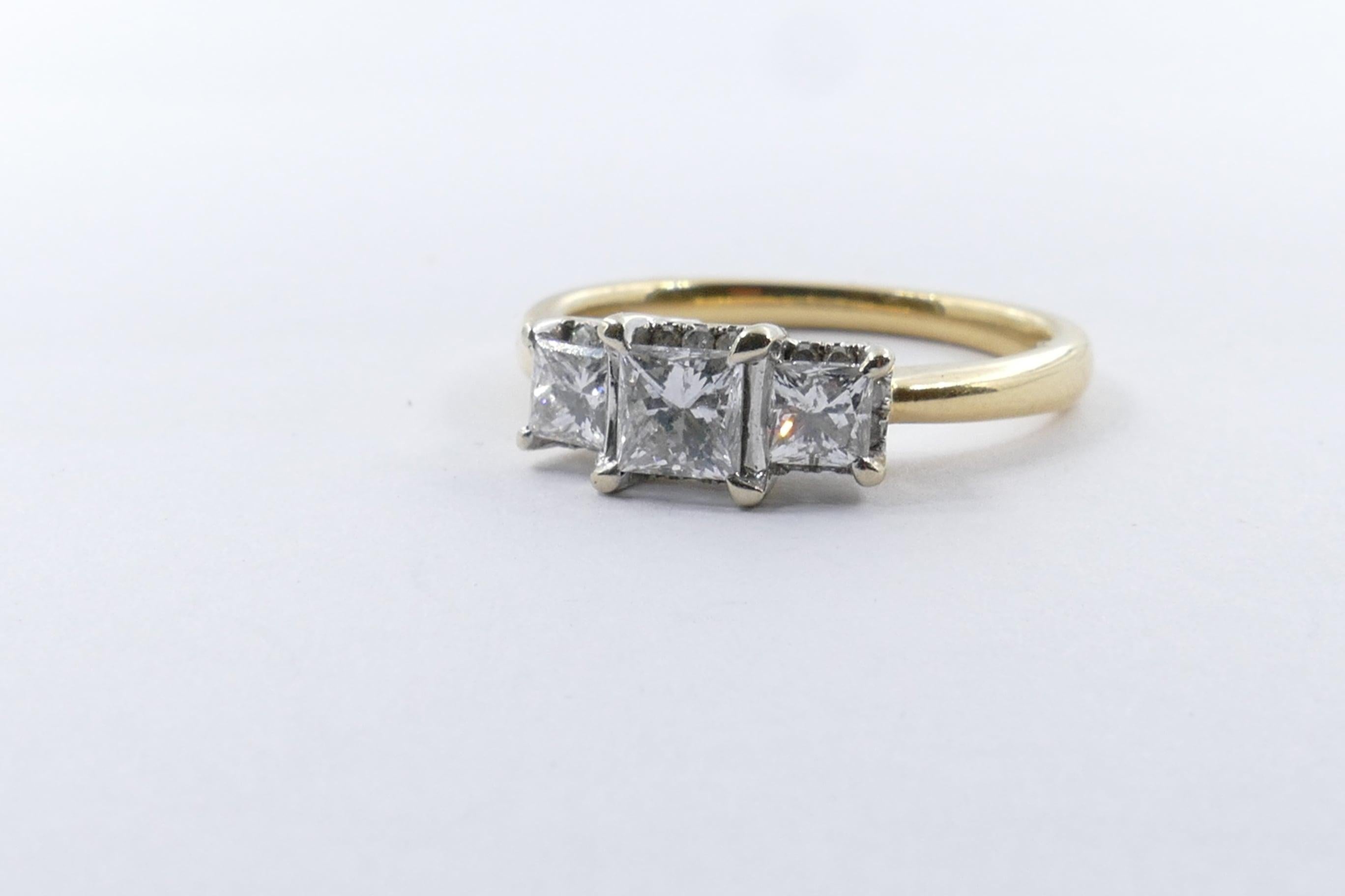 A Princess Cut near half carat Diamond, colour G, clarity SI1, 4 claw set is flanked by 2 other high quality Princess Cut Diamonds  totalling near half carat as well. Their colour is G, clarity SI1 to create  a very attractive 3 Stoner Ring.
The