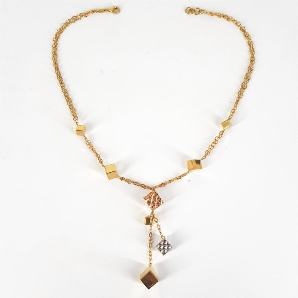 This beautifully crafted cubic designed necklace weighs 15grams. This necklace is set in 18carat Yellow, White & Rose Gold and is 42.5cm in length