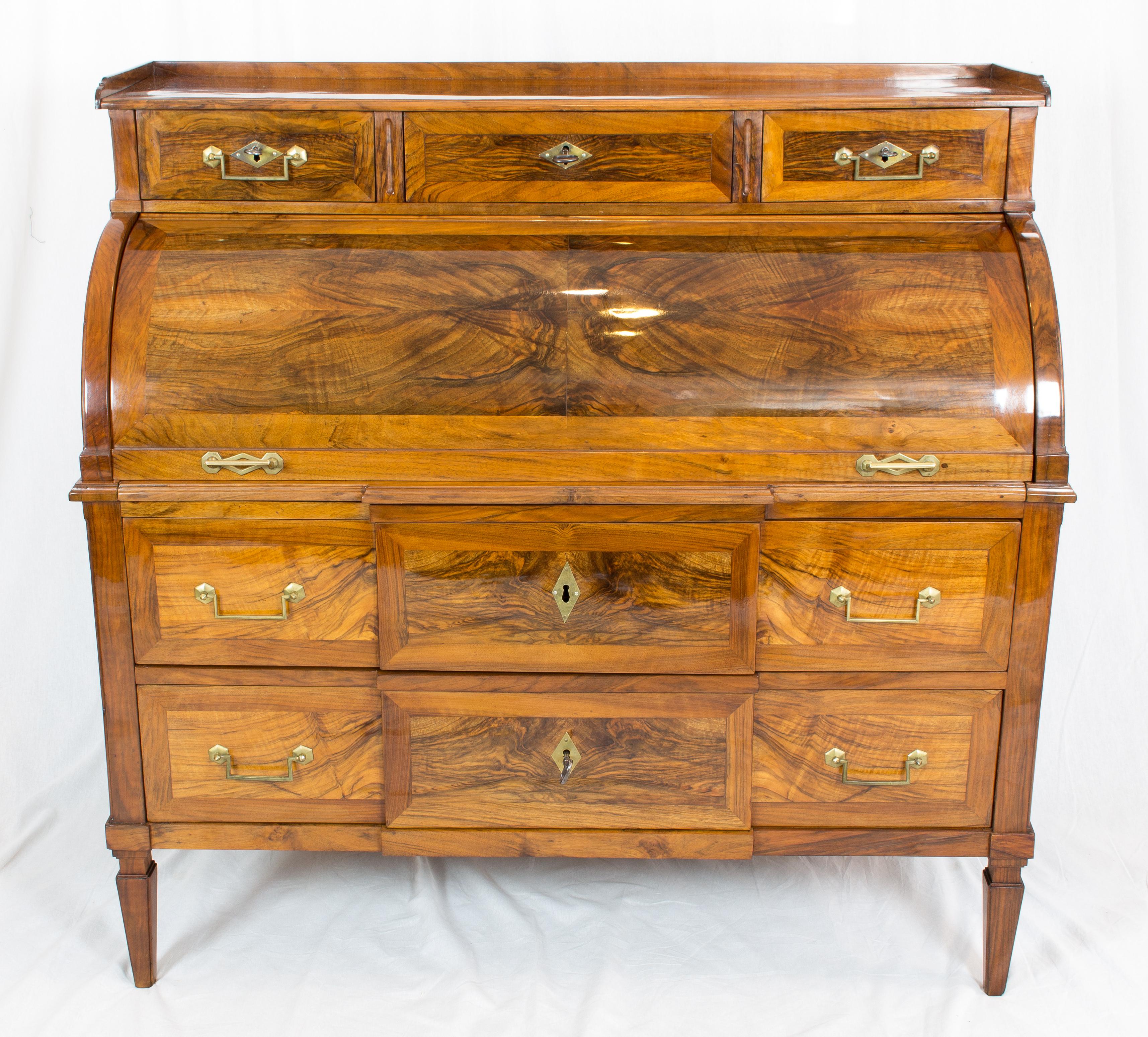 Beautiful cylinder Bureau from the time of Louis XVI circa 1780-1790. The Secretaire is made of thick saw walnut veneer on a pine wood body, the interior is made also with walnut veneer. The writing board can be pulled out and is lockable in closed
