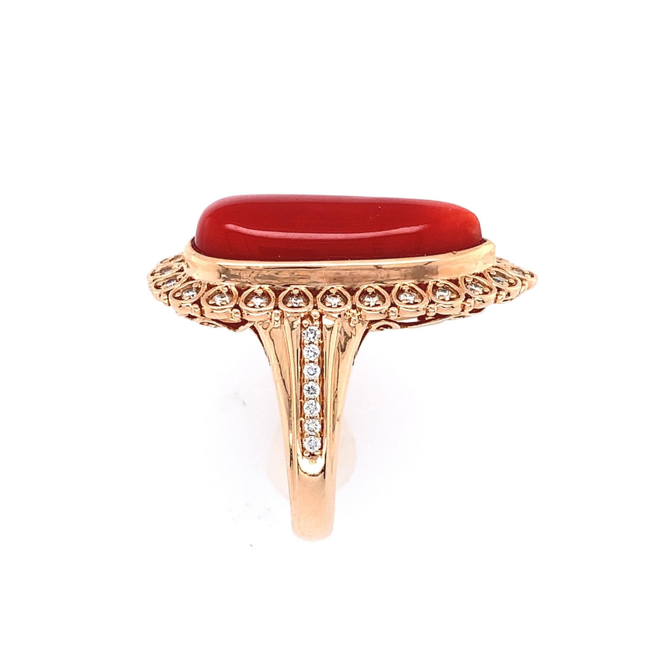 New 18K rose gold natural orange-red coral and diamond ring. The long pear shape cabochon coral weighs 12.05 carats and measures about 21mm x 8mm. Surrounding it are 24 round brilliant cut diamonds in the halo and and 14 round  diamond accents on
