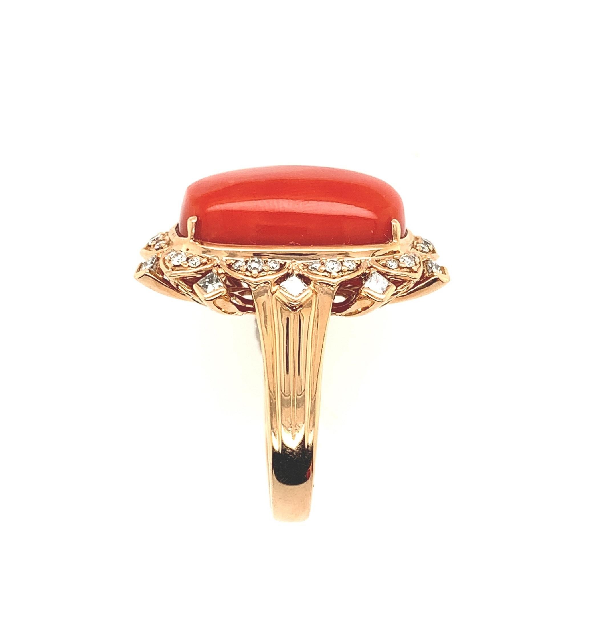 New 18K rose gold natural orange-red coral and diamond ring. Centered is a oval cushion cabochon coral weighing 17.65 carats and measures about 18mm x 12mm. Surrounding it are 30 round brilliant cut diamonds and 10 princess cut diamond accents