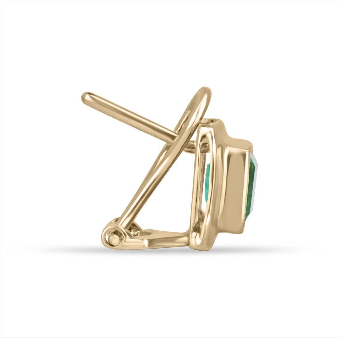 Elevate your style with our exquisite bezel-set emerald earrings, each showcasing mesmerizing Colombian emeralds with a medium vivid green hue and semi-transparent clarity. Crafted in luxurious 18k yellow gold and featuring an elegant latch-back