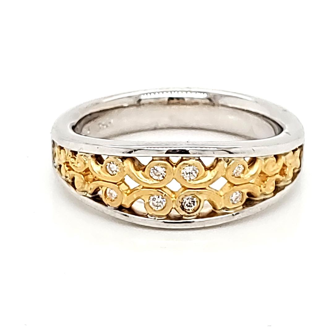 Adorned with 8 dazzling round brilliant diamonds, totaling 0.12 carats, delicately placed on an ascending gold swirl. 

This ring is a beautiful statement of refined taste. 

It is crafted in 18k and 24k white and yellow gold at 6.9 grams. 

It
