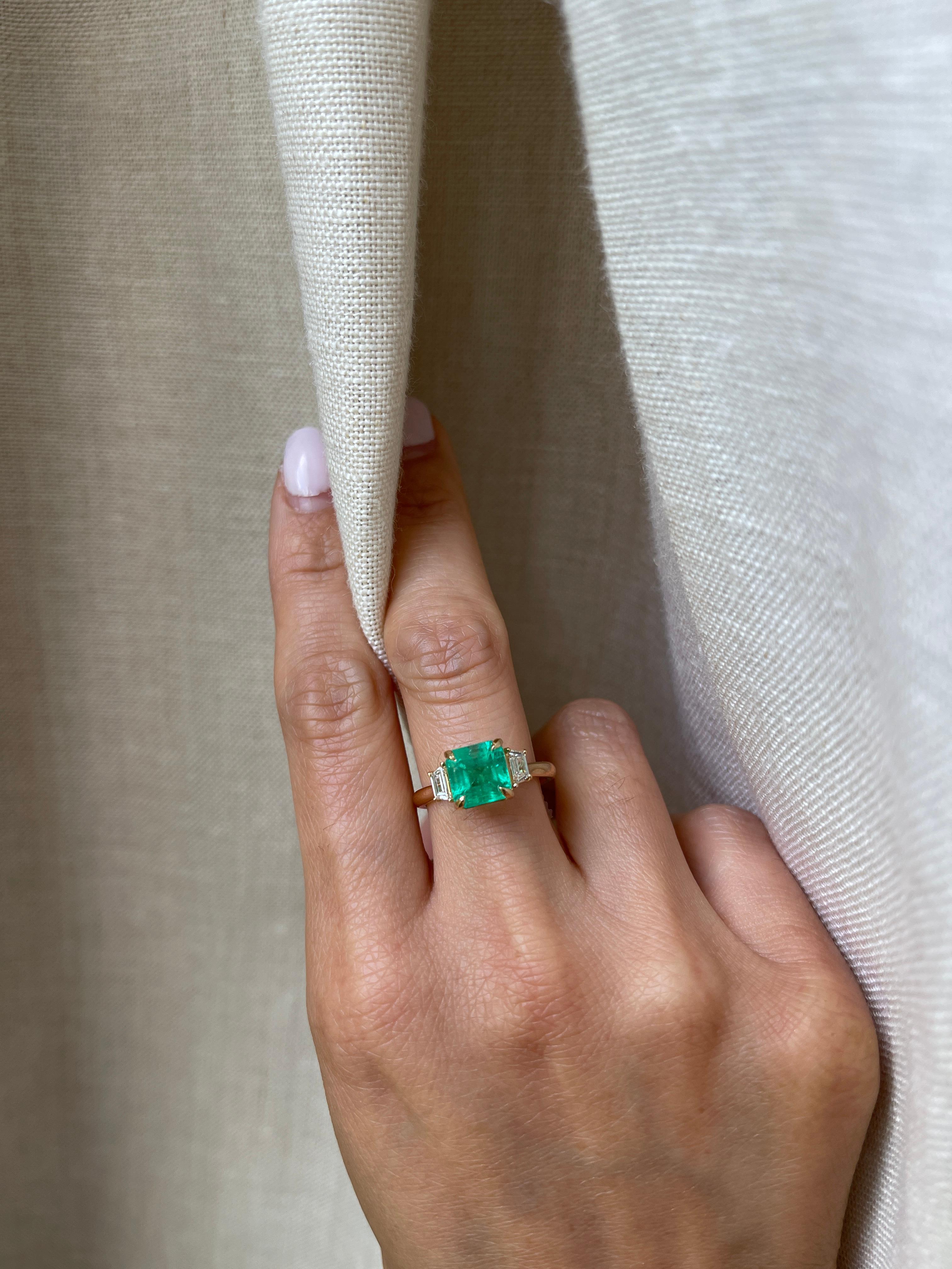 Natural Zambian emerald with trapezoid diamonds set on 18k yellow gold. 

Metal: 18K Yellow Gold
Stone: Natural Zambian Emerald
Stone Size: 7.5mm x 7.5mm
Stone Weight: 2.5 Carat
Accent Stone: Natural Diamond
Diamond Shape: Trapezoid
Diamond Color