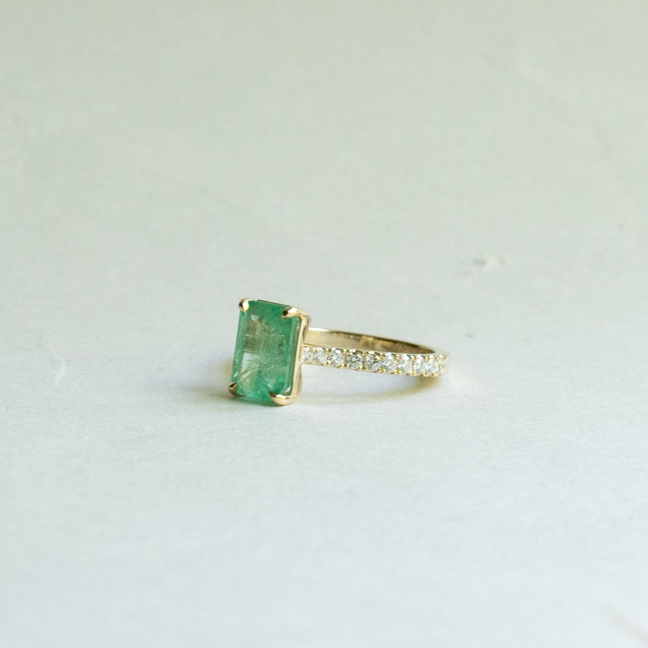 Metal: 14k yellow gold
Stone: Natural emerald 
Stone size: 2.54 carat
Accent Stone: Diamond
Accent stone weight: 0.50 carat 
Diamond color and clarity: G+, VS
Band Width: 2mm