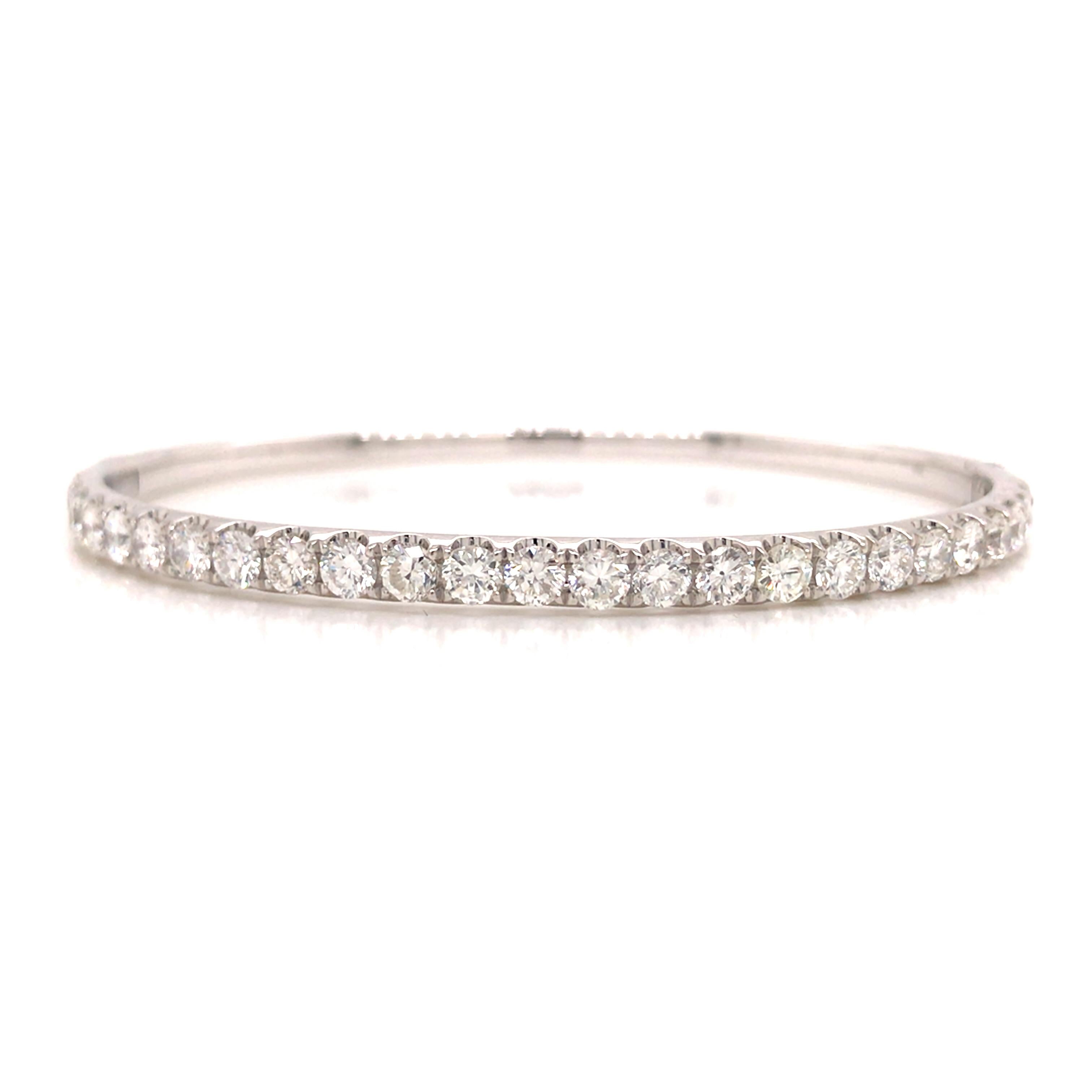 Diamond Bangle in 18K White Gold.  (25) Round Brilliant Cut Diamonds weighing 3.0 carat total weight, G-H in color and VS-SI in clarity are expertly set.  The Bangle measures 6 1/4 inch inner circumference and 1/8 inch in width.  Hinge opening.
