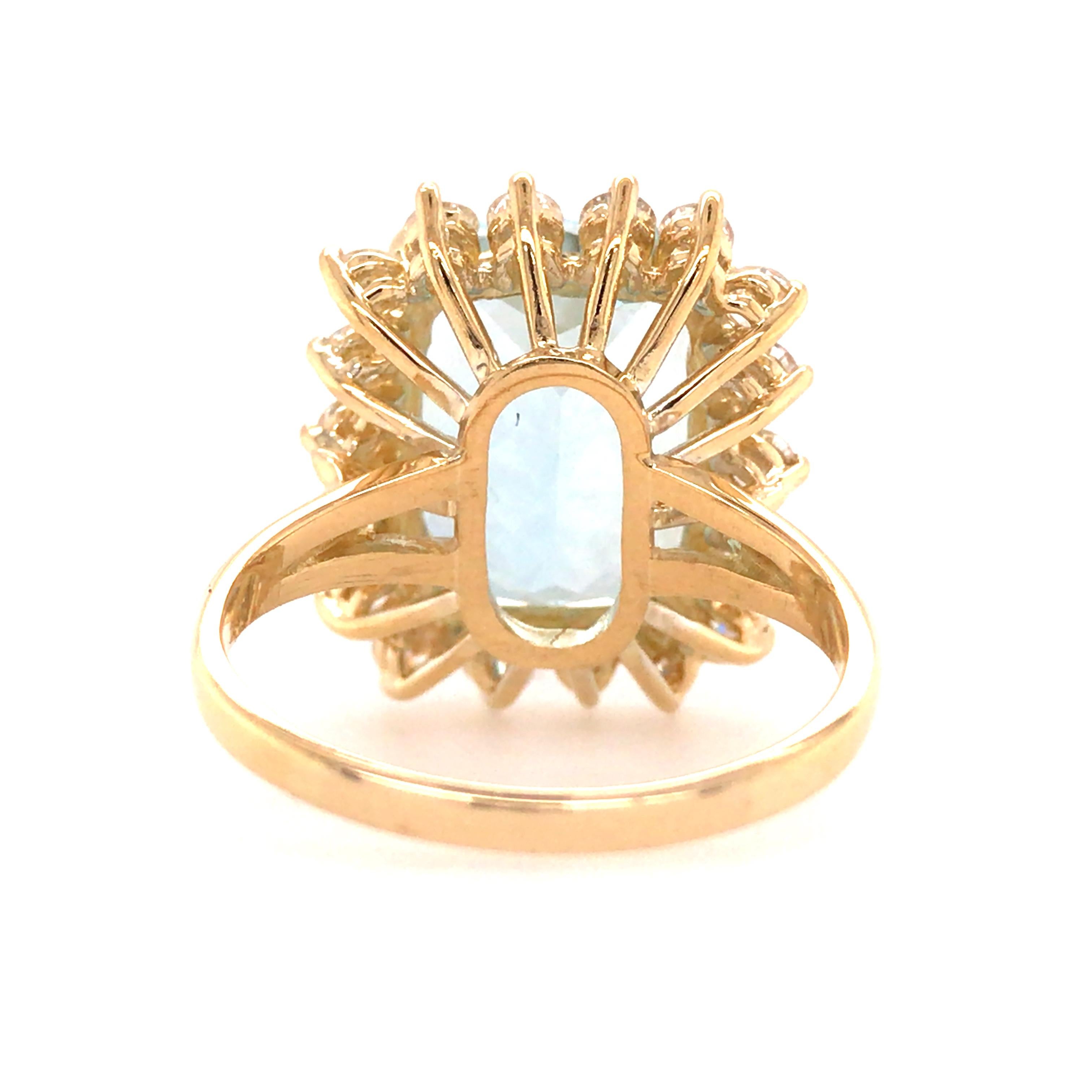 6.59 Carat Aquamarine and Diamond Halo in 18K Yellow Gold. (18) Round Brilliant Cut Diamonds weighing .97 carat total weight G-H in color and VS-SI in clarity are expertly set in a halo around the Aquamarine Gemstone.  The Ring measure 3/4 inch in