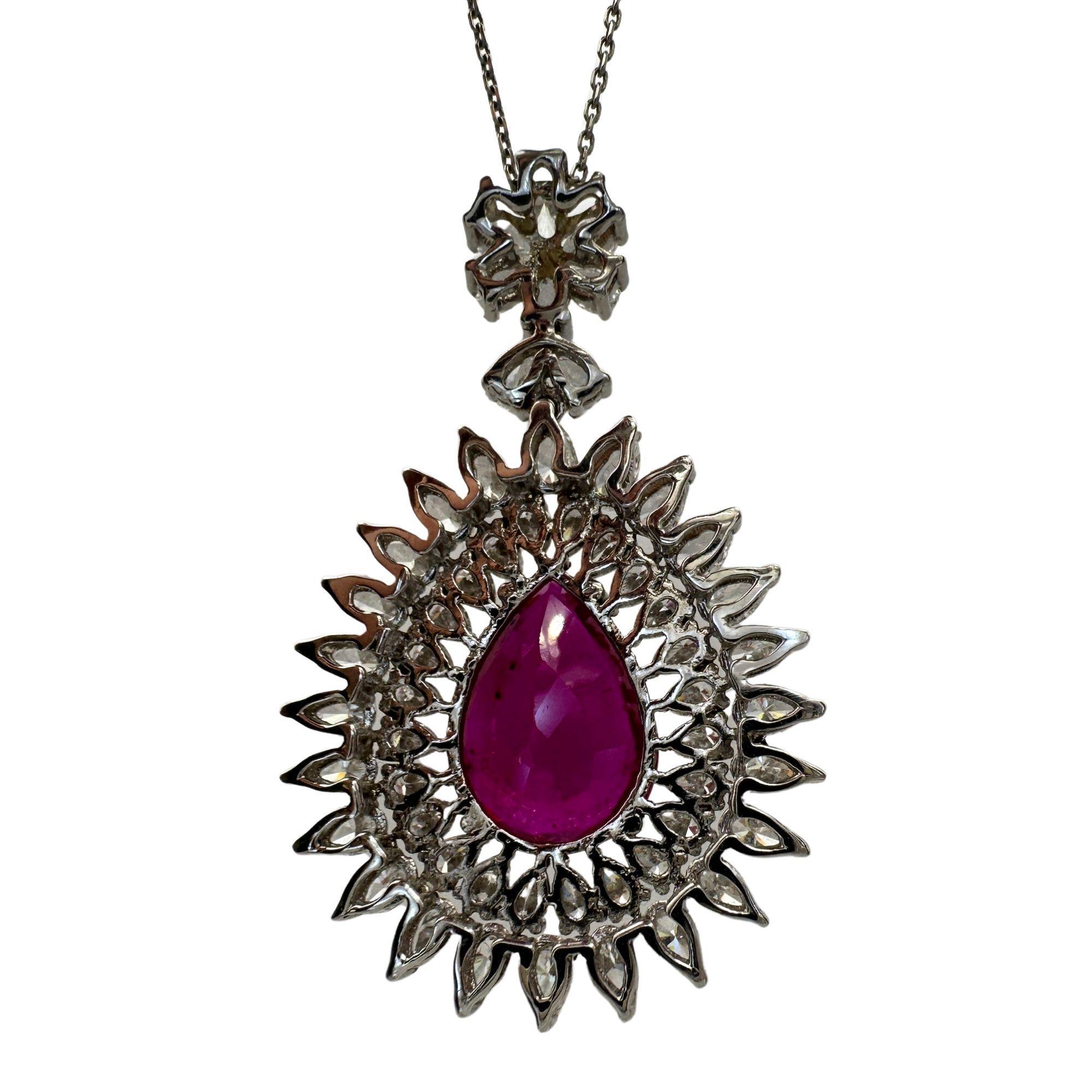 Elevate any outfit with our stunning 18k African Ruby and Diamond Pendant Necklace. Crafted in 18k white gold, this necklace features a 17.5 inch chain and a dazzling 1.75 inch pendant adorned with princess cut diamonds (4.55 carats) and a vibrant