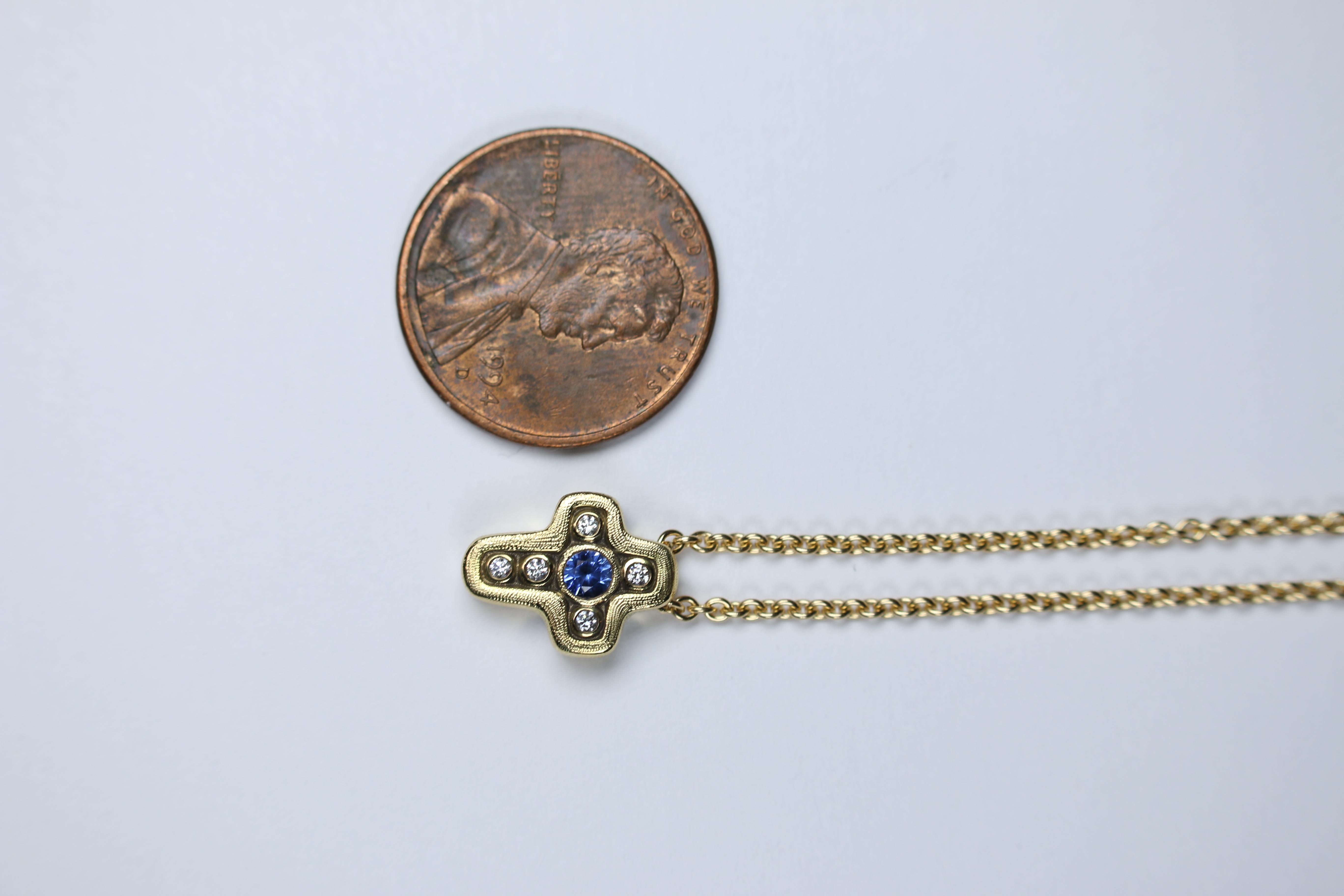 Alex Sepkus has masterfully crafted this beautiful cross pendant of 18k gold, showcasing 5 (0.05ct) Diamonds with a (0.15ct.) Sapphire at its center. This item is a perfect piece to wear alone or stack it with any other Alex Sepkus Pieces!