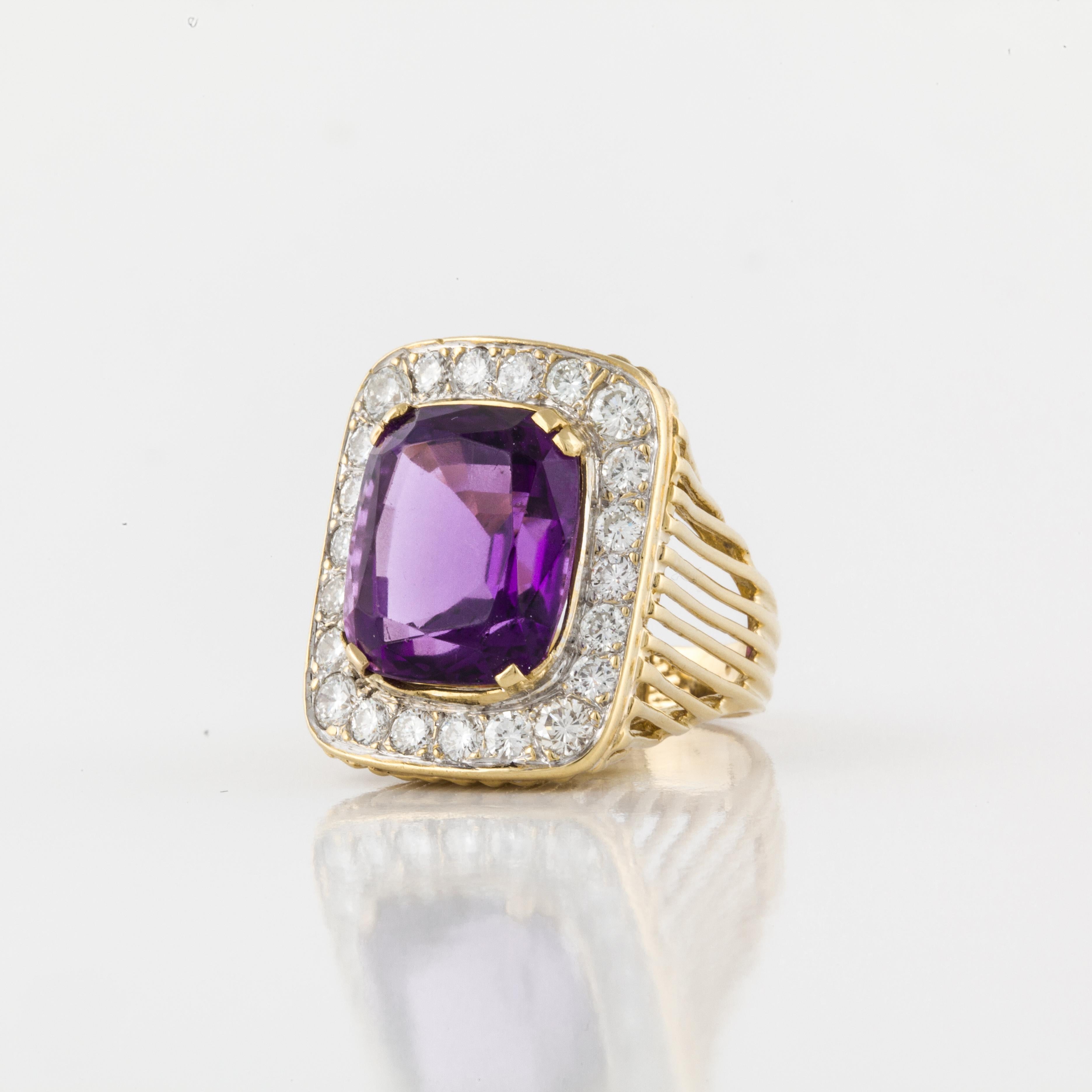 18K yellow gold amethyst and diamond ring.  The amethyst is a cushion cut and surrounded by twenty-two round diamonds totaling 1.70 carats; they are G-I in color and VS1-SI1 in clarity.  Ring is currently a size 6-1/4.  Measures 7/8