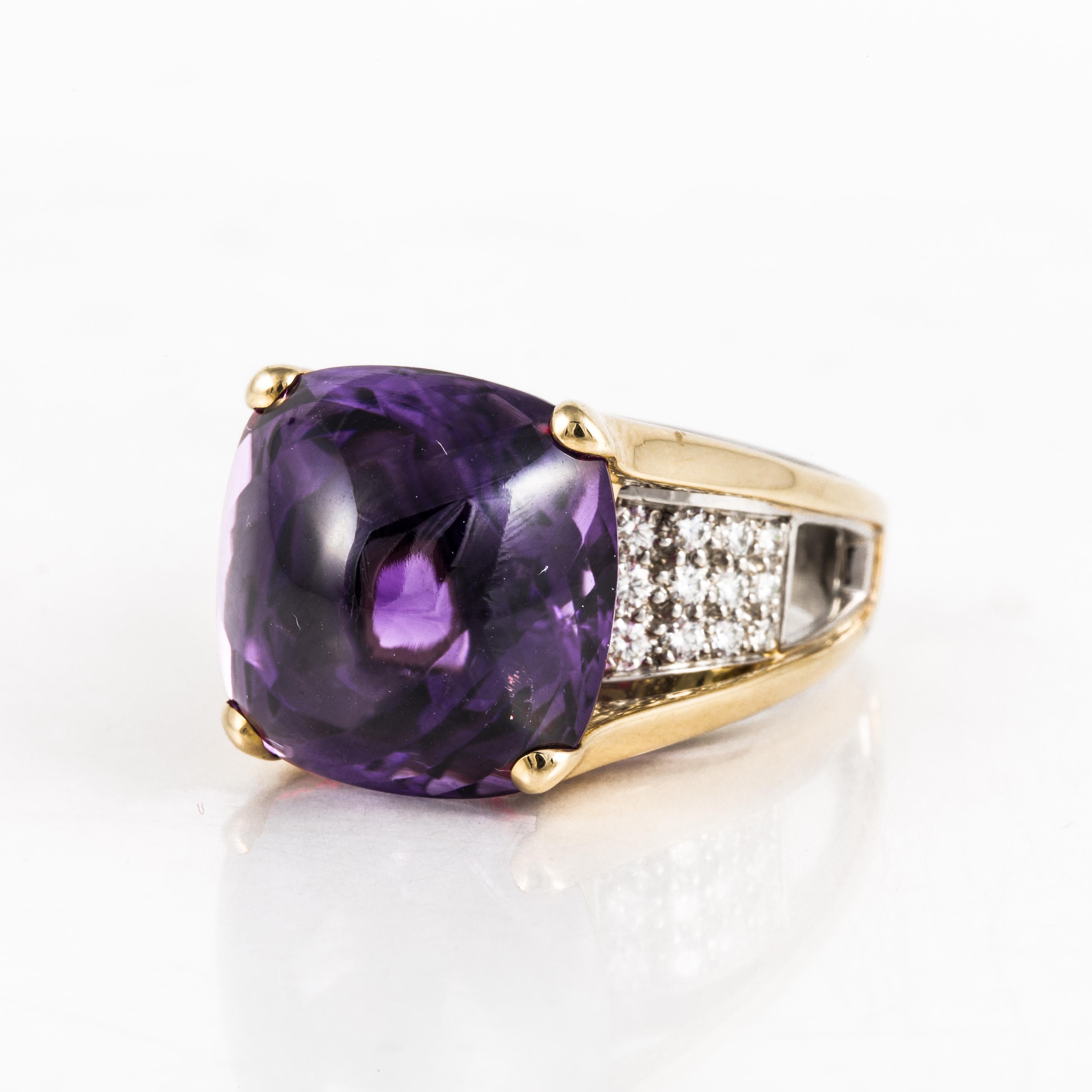 18K yellow and white gold ring featuring a cabochon amethyst sitting above diamonds.  The twenty-four round diamonds total 1 carat, G-H color and VS clarity.  The ring is currently a size 10.  Measures 13/16