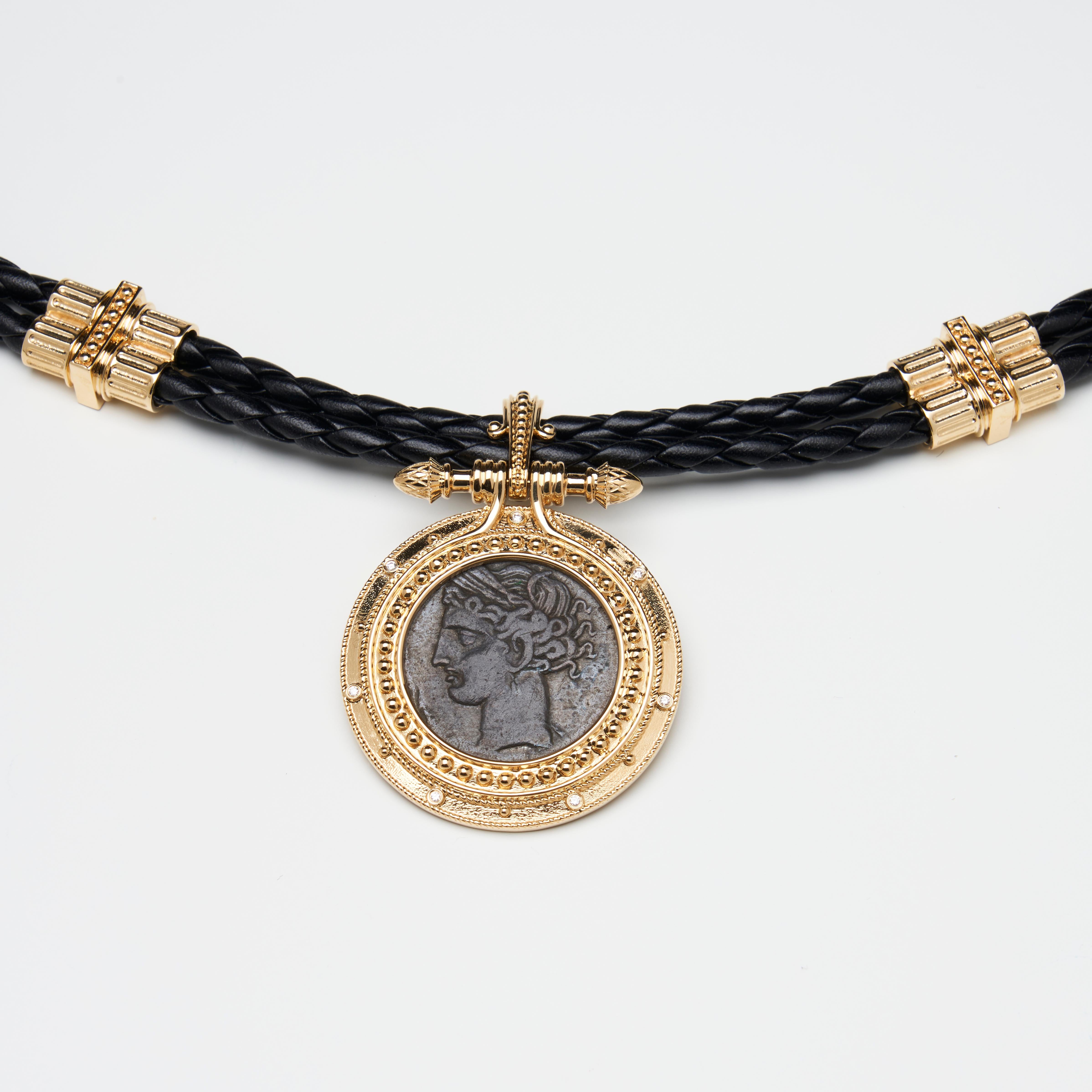 18-karat yellow gold pendant
Leather Cord with 18K gold decoration
Ancient, authentic Greek bronze coin of the head of Tanit center inset. Tanit coin from ancient Carthage from 300-264 B.C
Decorate with white diamonds
The total weight of the pendant