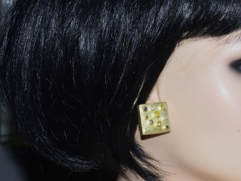 18K yellow gold earrings with a total of 20 round brilliant cut diamonds bezel set on these square cube like earrings. The diamonds range from white (near colorless) to fancy yellows and fancy rootbeer colored diamonds. The weights have been