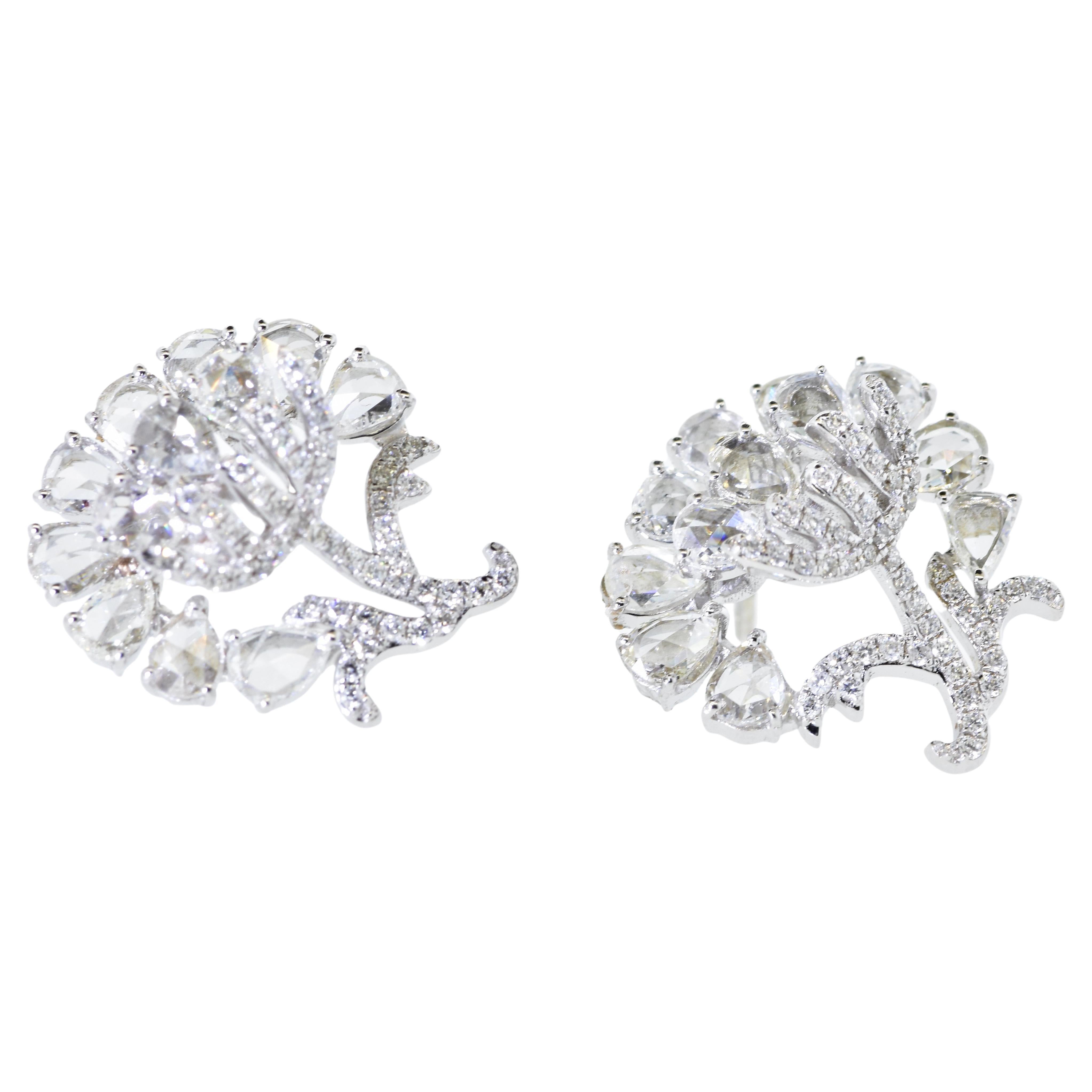 Fine white diamonds are well set in these contemporary flower motif 18K white gold earrings.  There are 3 cts. of diamonds in both the round brilliant cut diamonds and the rose cut diamonds.  The diamonds are near colorless and very slightly