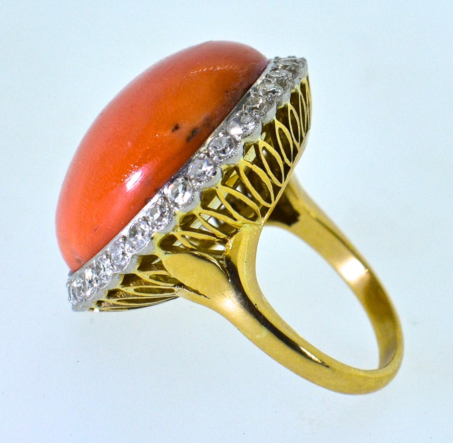 Natural Mediterranean  coral surrounded by white diamonds.  There are approximately 1.5 cts. of round diamonds all near colorless, H, and very slightly included.  The gallery work underneath is done quite well.  The natural coral weighs
