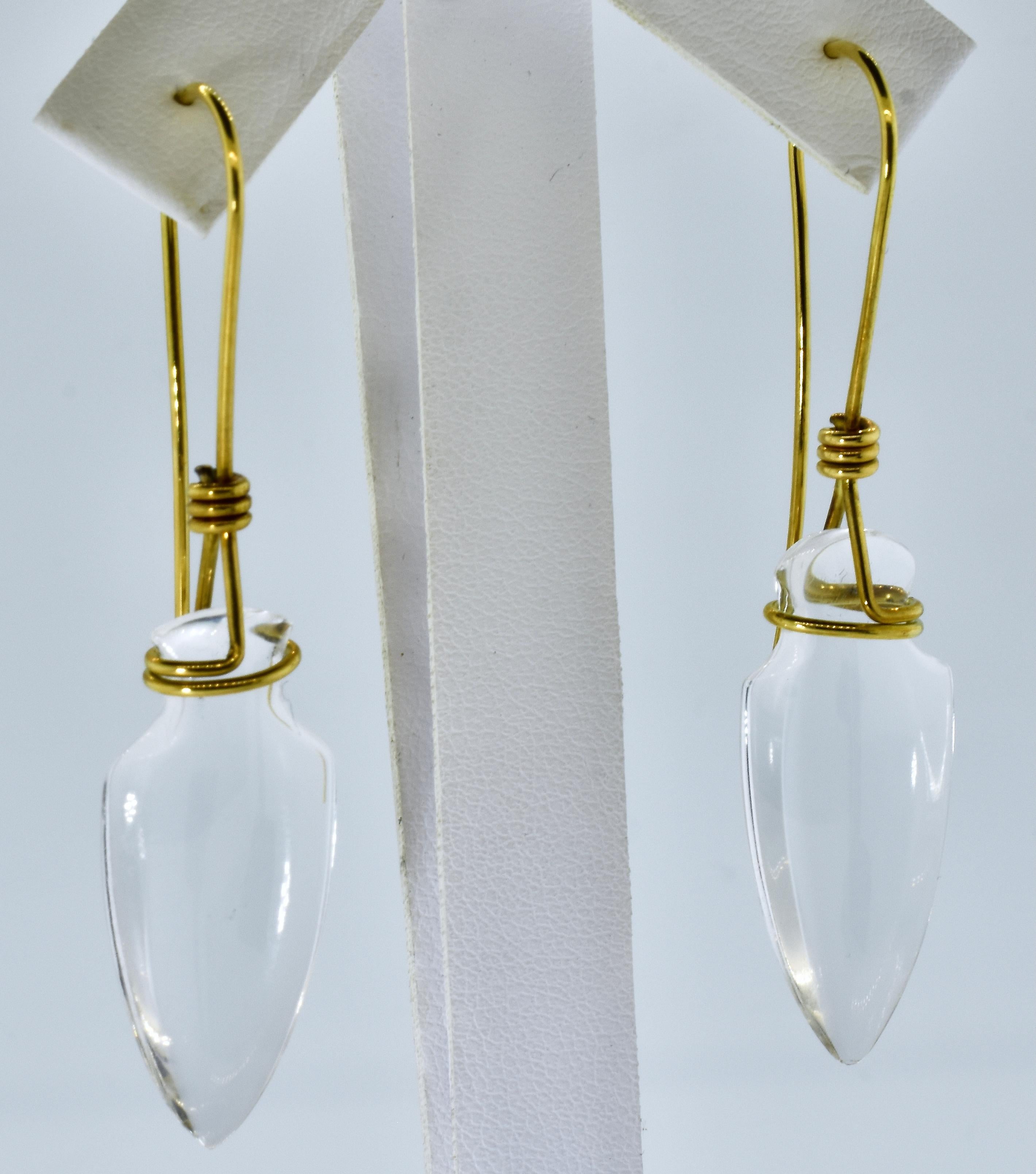 Tina Chow earrings in 18K yellow gold and natural rock crystal.  The arrow-head shaped clear rock crystal has a high polish and held artfully by 18K wire.  The rock crystal measures 1.25 inches by .5 inches.  The entire earrings is approximately