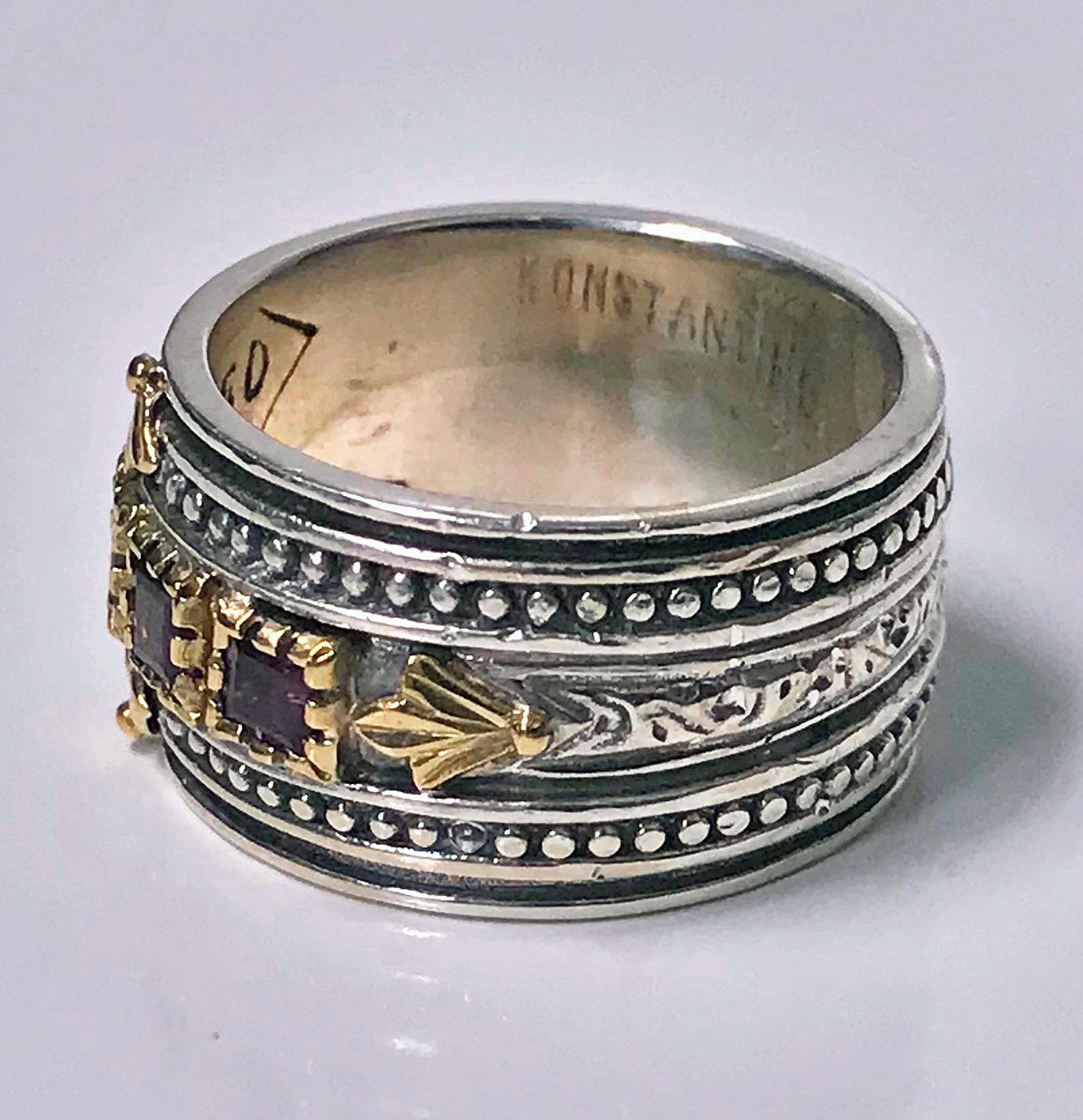 18K and Sterling Konstantino Rhodolite Band Ring. The Ring 18K claw and foliate set with five square cut rhodolites surmounted on sterling bead and foliate design band. Stamped 750 925 Konstantino on interior. Width of Band: 11.70mm. Ring Size: 7.