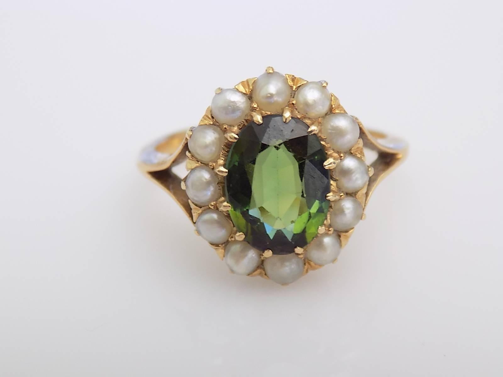 A Gorgeous Victorian c.1890 18 Carat Yellow Gold, Split Seed Pearl and Natural Green Tourmaline cluster ring. Beautiful green colour Tourmaline surrounded by 12 split Seed pearls in a Halo setting on a split shoulders. Perfect as Engagement or
