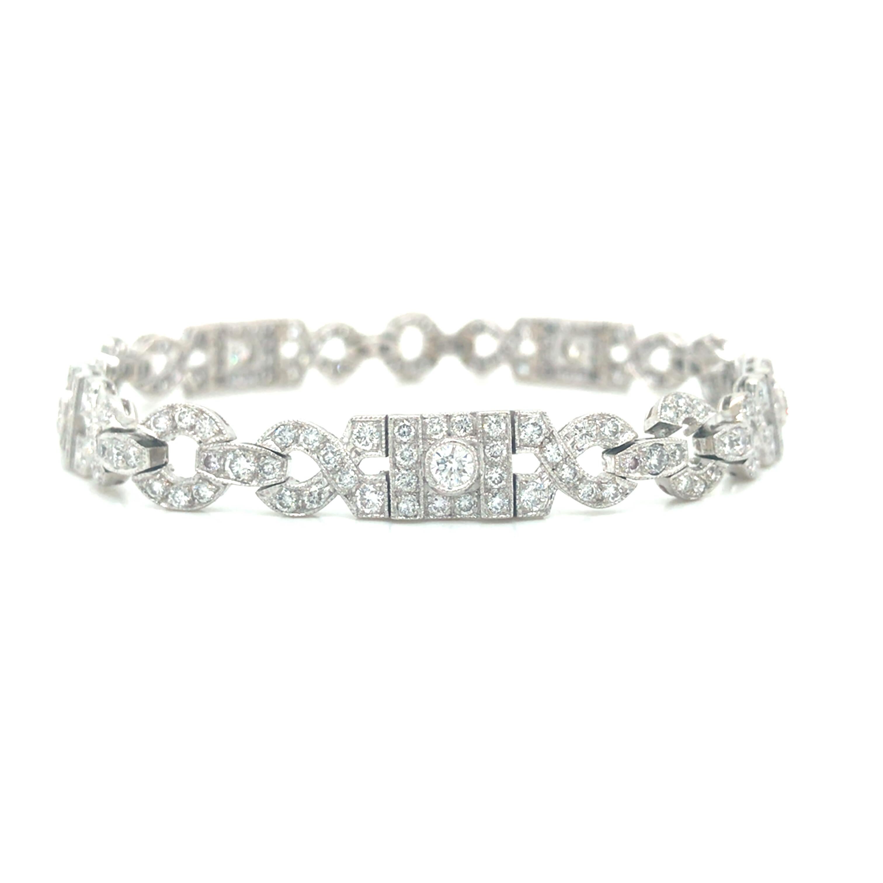 Art Deco Diamond Pave Geometric Bracelet in 18K White Gold.  235 Round Brilliant Cut Diamonds weighing 7.20 carat total weight, G-H in color and VS-SI in clarity are expertly set.  The Bracelet measures 7 1/4 inch in length and 5/16 inch in width. 