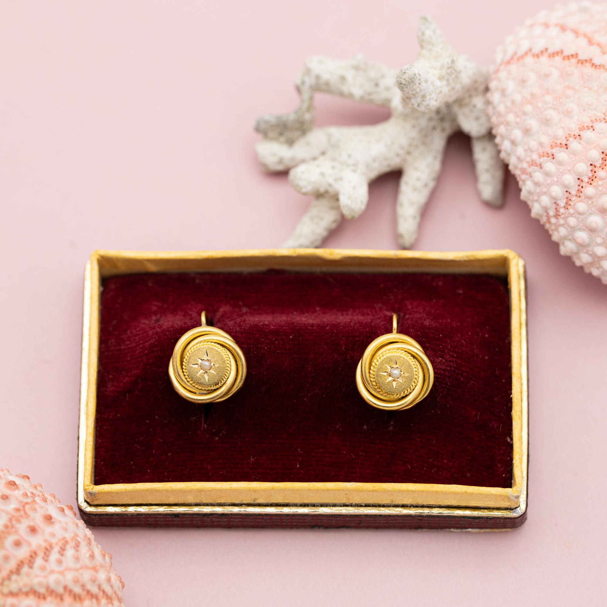 For sale is this wonderful pair of late Victorian 18 Karat yellow gold lovers knot earrings. It represents the unbreakable bond and eternal connection between two lovers. They are set with two small pearls which bring some colour to the jewels.