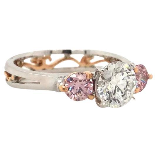 Australian White Diamond and Australian Argyle Pink diamond trilogy ring from Mondial Pink Diamond Atelier. The central diamond four claw set in this ring is an Australian white diamond from the now closed Argyle diamond mine. This diamond weighs