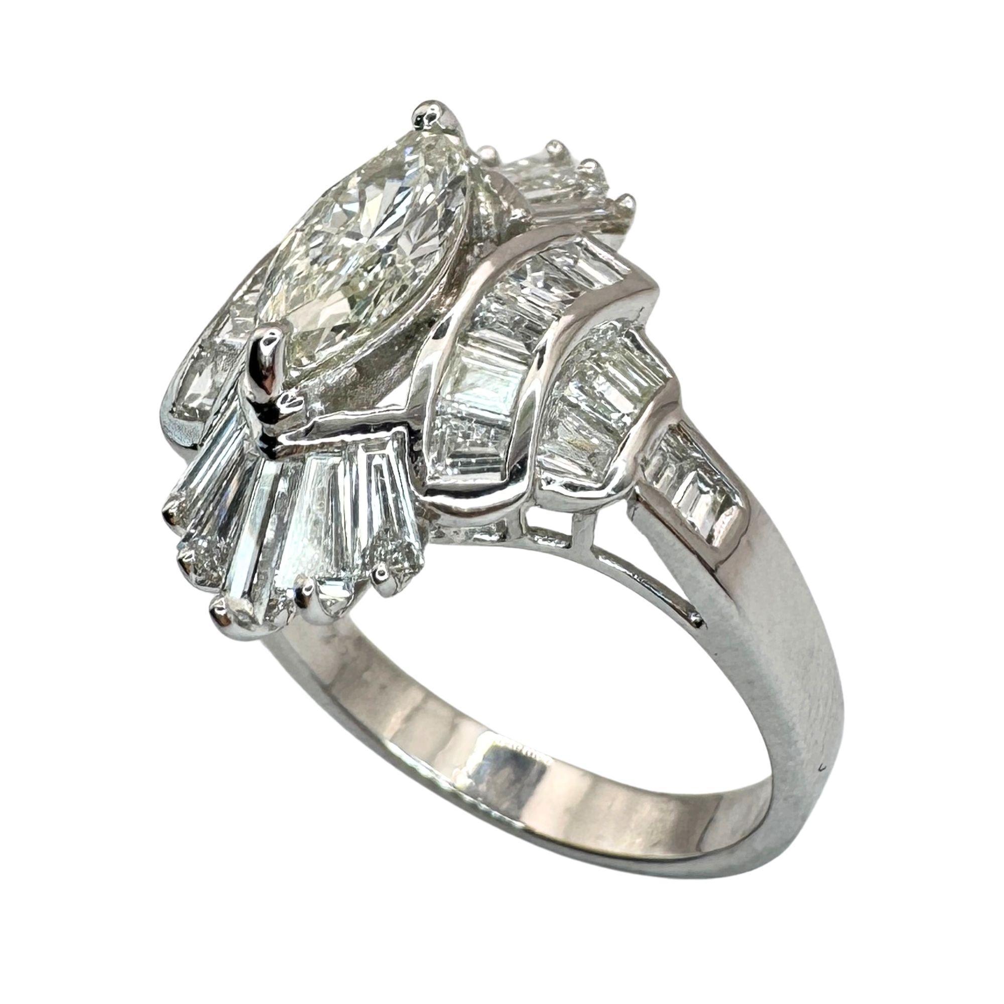 This 18k Baguette and Marquise Cut Diamond Navette Ring exudes elegance and luxury with its intricate design and 1.79 carats of dazzling diamonds. Crafted in 18k white gold, this ring is marked with a 