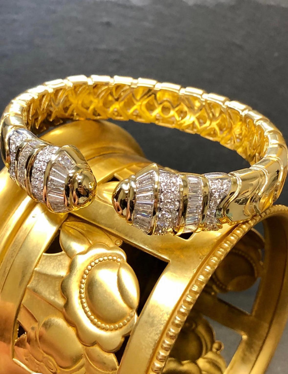A heavy and very well made cuff bracelet done in 18K yellow gold and set with approximately 6cttw in G-H color Vs1-2 clarity baguette and round diamonds.
THIS IS ONLY FOR THE SALE OF (1) DIAMOND CUFF. ANOTHER IN SAPPHIRE AND DIAMOND IS ALSO