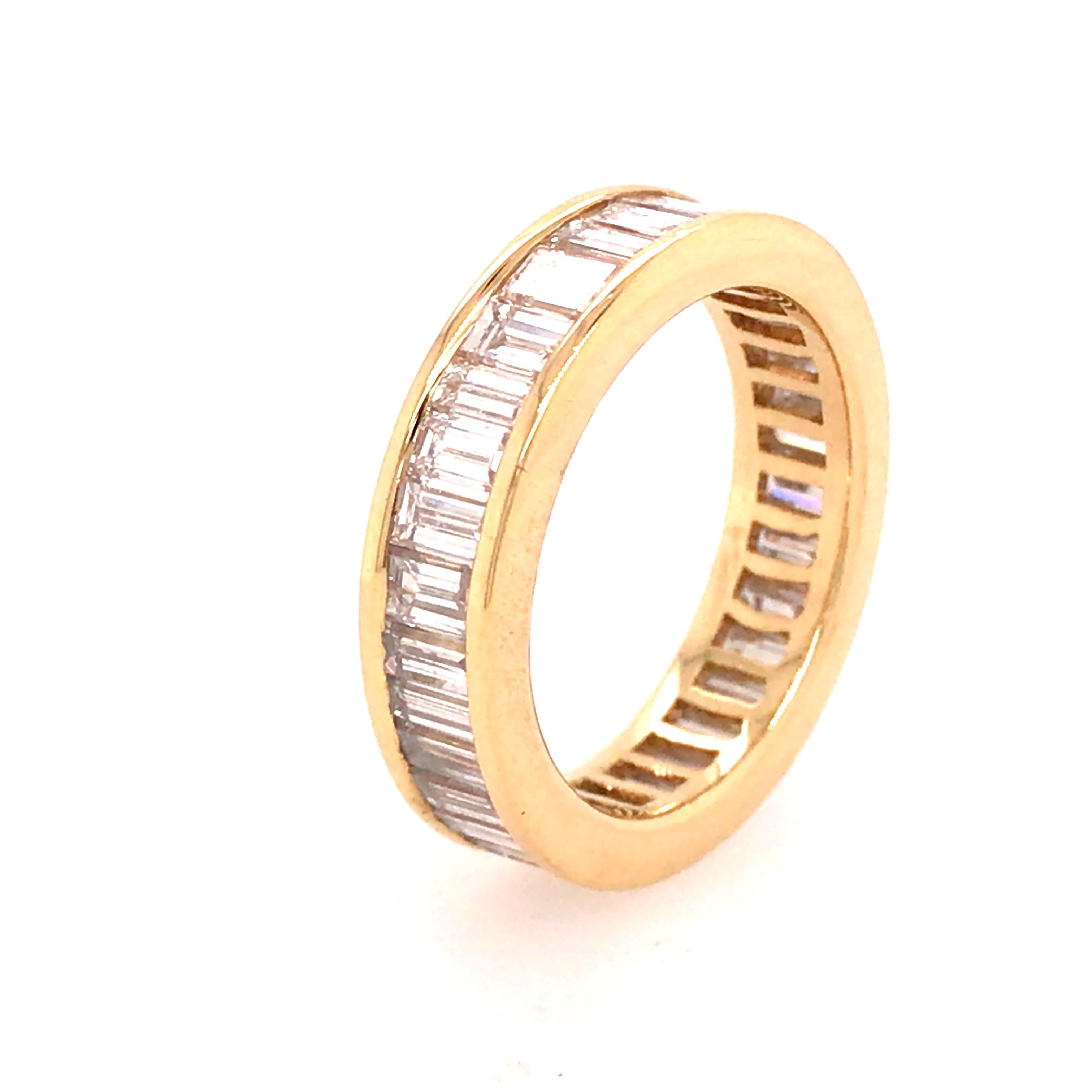 Baguette Diamond Eternity Band in 18K Yellow Gold.  Baguette Diamonds weighing 4.08 carat total weight, F-G in color and VS in clarity are expertly set.  The Ring measures 1/4 inch in width.  Ring size 7.  5.6 Grams.