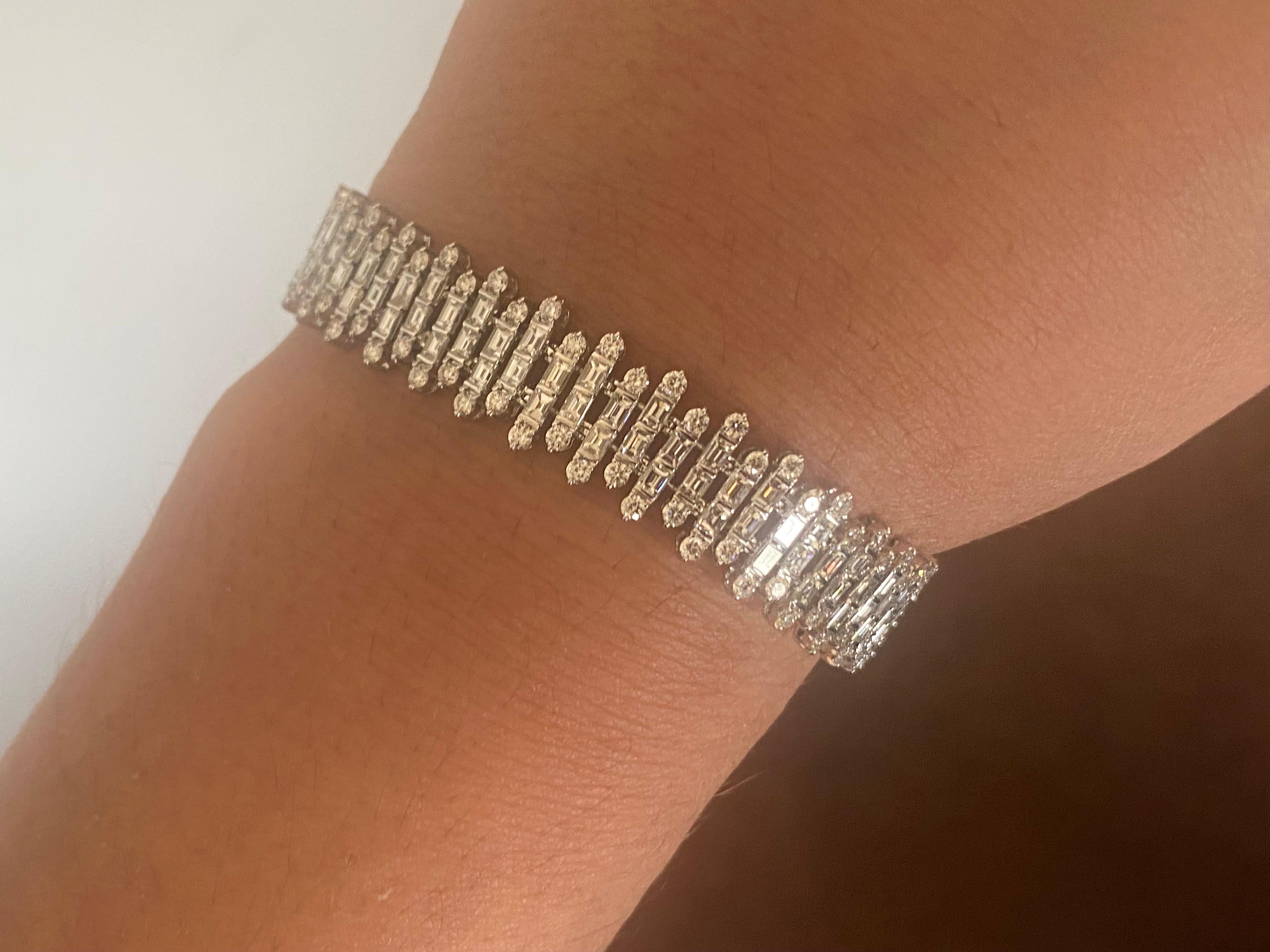 Diamond tennis bracelet set in 18K white gold. The bracelet is set with tapered baguettes and round stones. The color of the stones are F, the clarity is VS1-VS2. The total weight is 9.45 carats.