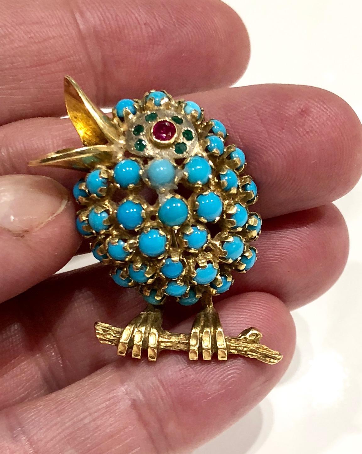 18k gold bird brooch set with turquoise with a ruby and emerald eye detail  .
circa 1960s