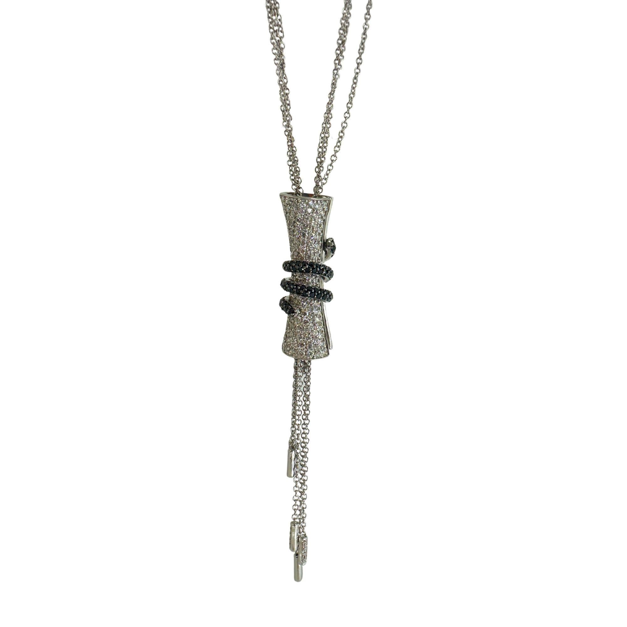 Add elegance to your outfit with our 18k Black and White Diamond Tassel Necklace. Crafted in 18k white gold, this 16 inch chain features a stunning 3 inch pendant adorned with 1.39 carats of sparkling white diamonds and 0.89 carats of bold black