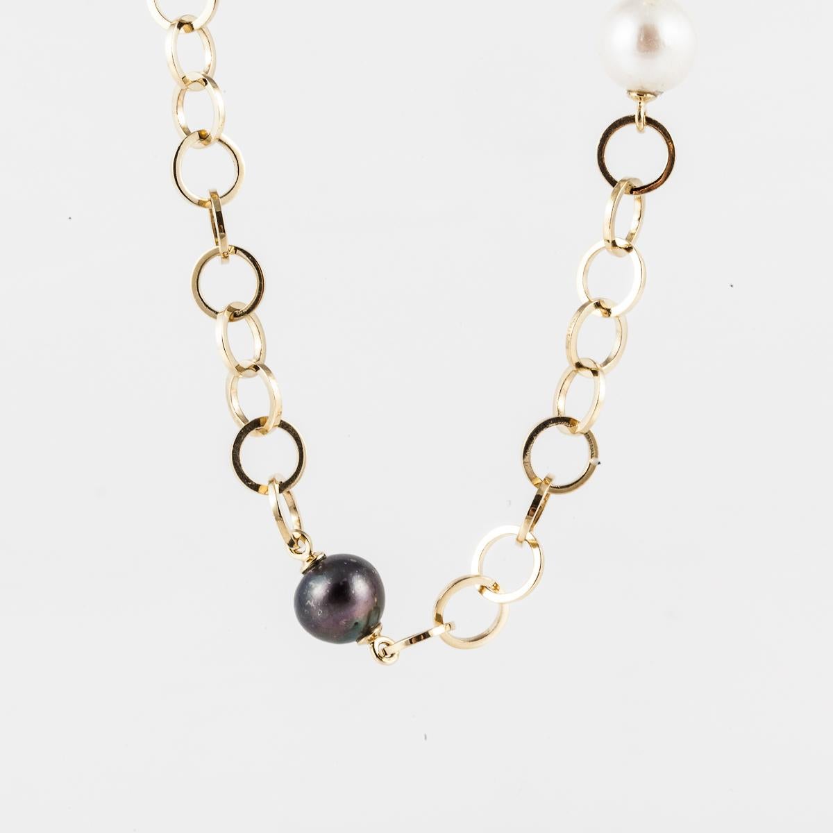 18K yellow gold necklace with interlocking circle links.  Interspersed are five white cultured pearls and five Tahitian black pearls that measure 10mm.  Necklace measures 31 inches in length and the links are 3/8 inches wide.