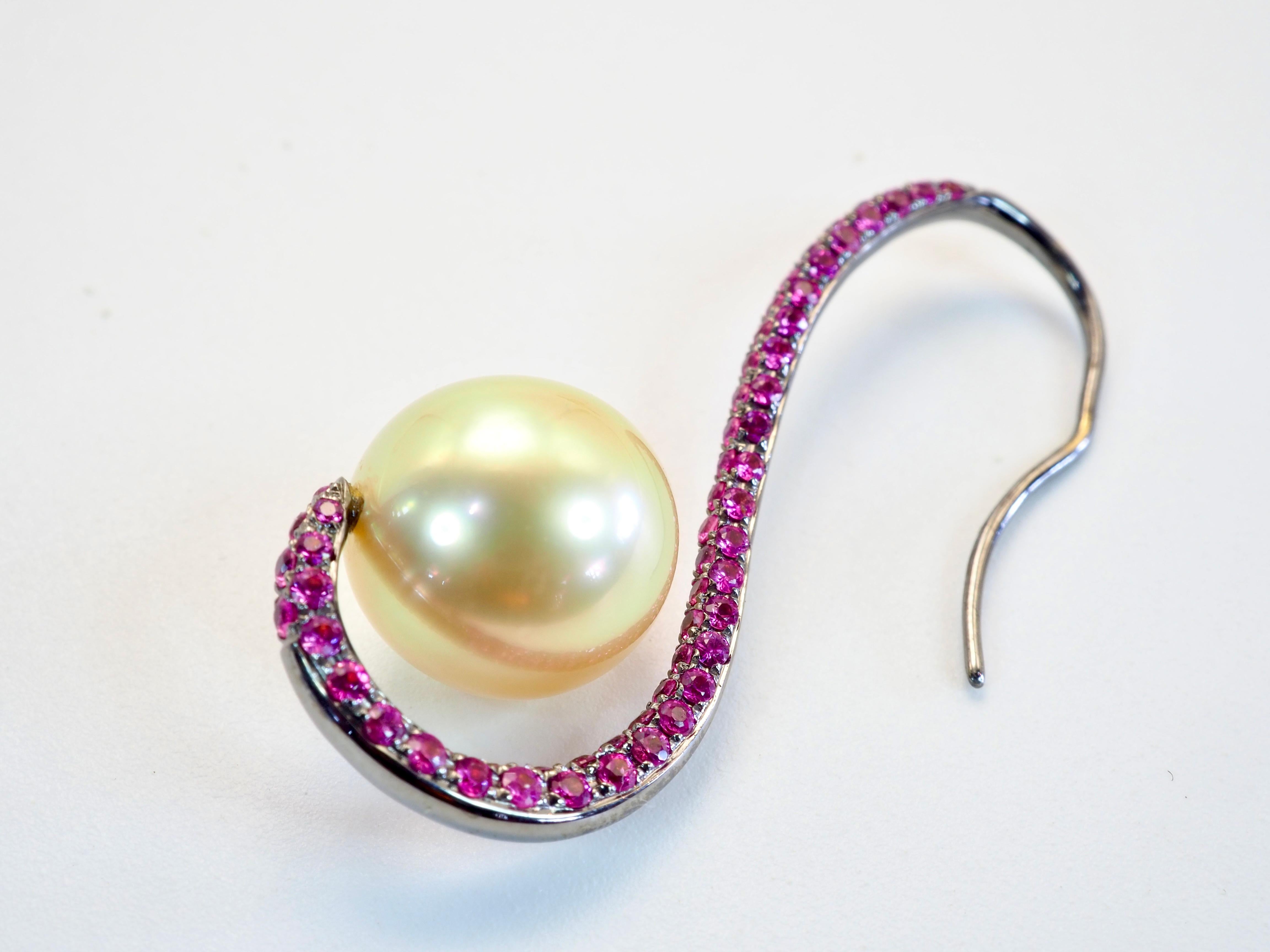 Majestic pearl piece that is very hard to come by! The glorious dangle earring is equipped with rare perfectly round pair of golden south sea pearls of decent size and physique! Pave pink sapphires glitters the piece adding saturation of color into