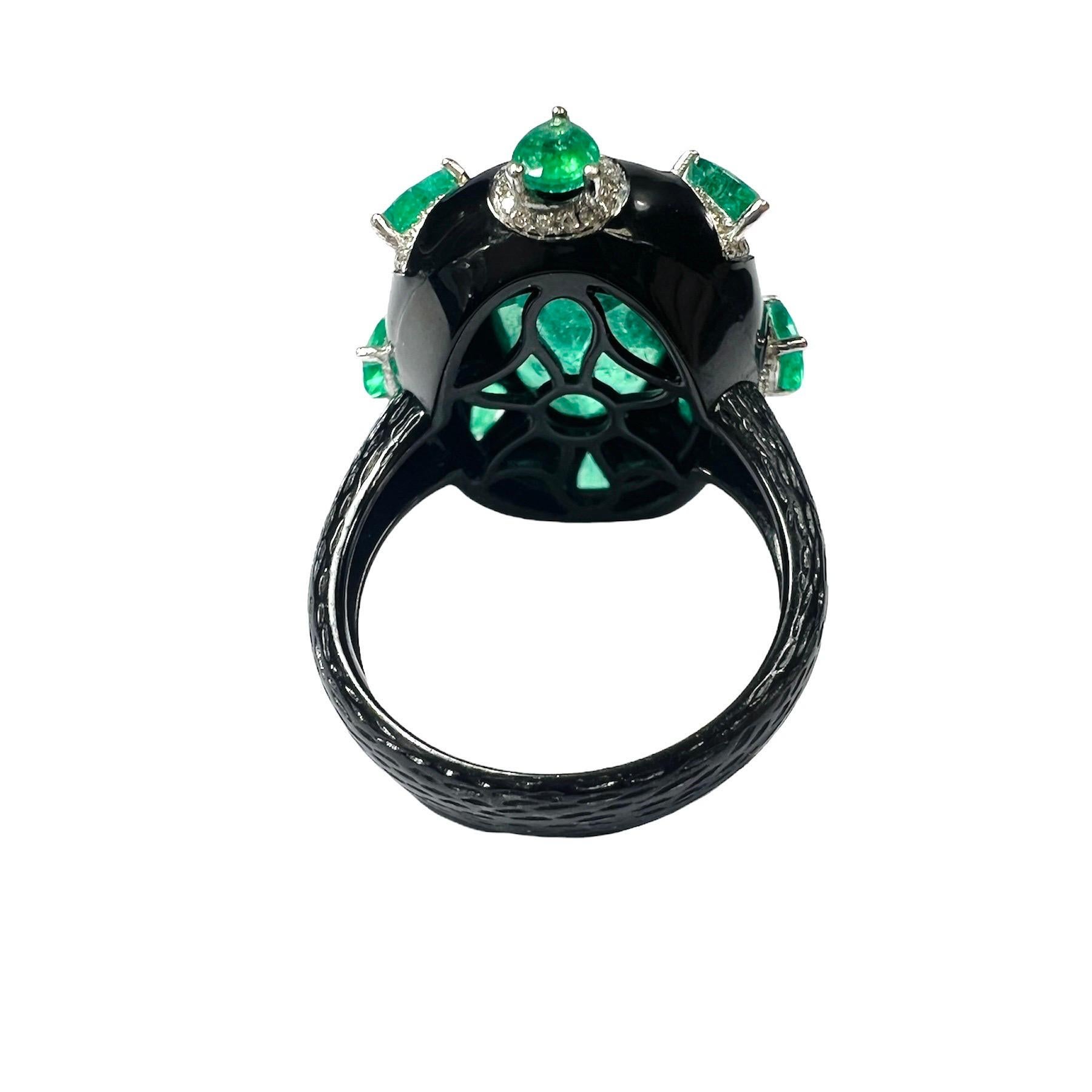  18K Black Gold Colombian Emerald and Diamond Ring Size 6.5

Featuring a solid 18K gold ring centering a 13x9mm glowing Green emerald surrounded by 8 small pear emeralds each in a diamond halo. 

The emerald is approximately 4 carats.

The ring is