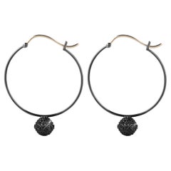 18k black gold hoop earrings with black diamond-encrusted orbs