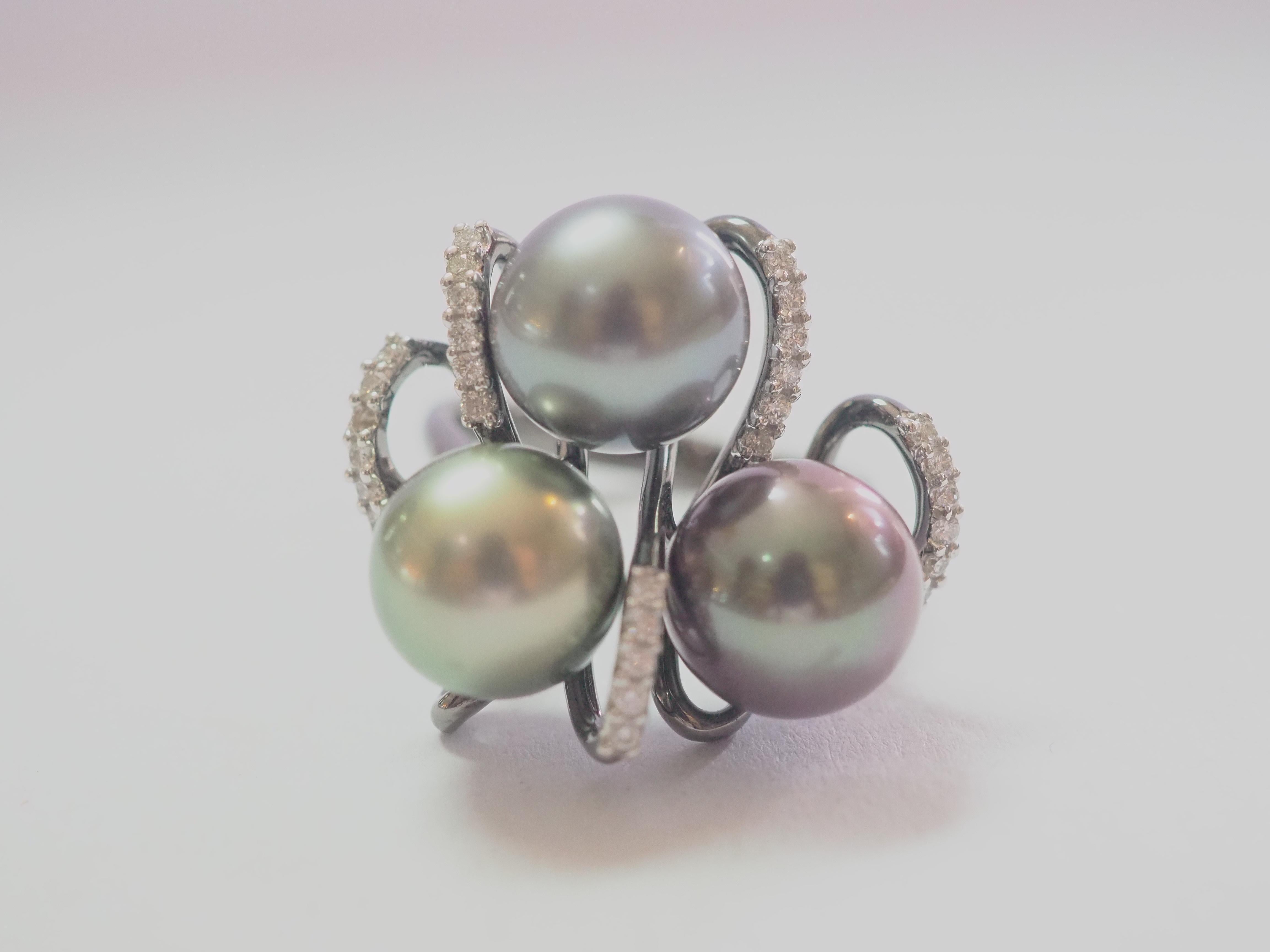Auction Estimate:
$1,600 - $3,500

This brilliant ring is adorned with 3 rare and beautiful Tahitian pearls! The pearls are perfectly round and has little to no visible blemishes. The color has different of black including brownish, metallic and