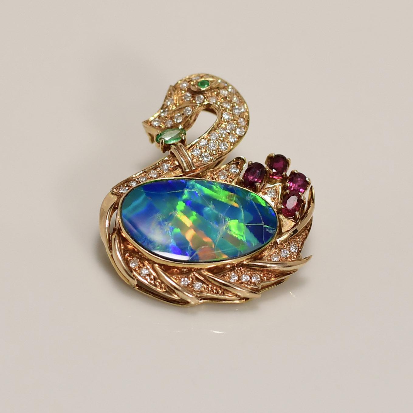 Dazzle and enchant with this exquisite 18K Black Opal and Diamond Swan Brooch, a true masterpiece of jewelry artistry. Crafted in luxurious 18K gold, the brooch boasts a graceful swan design adorned with mesmerizing black opals that shimmer with a