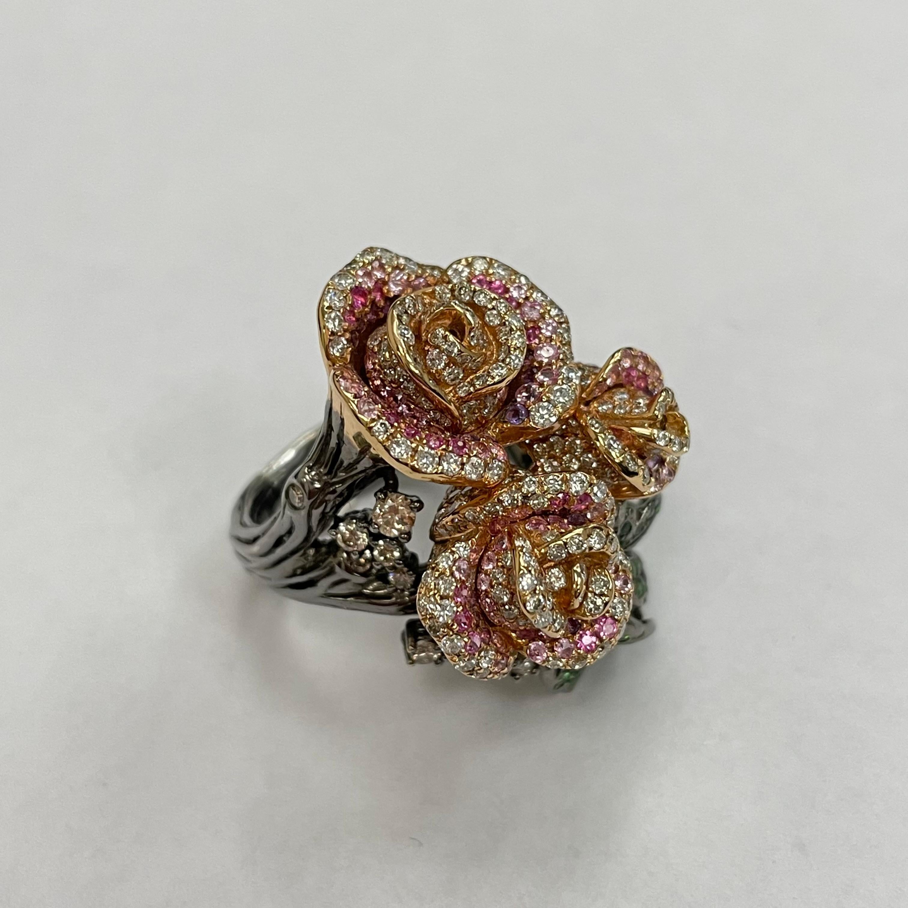 A stunning and stylish three-dimensional rose ring, set with brillant-cut of diamond , brown diamond, tsavorite, pink sapphire and amethyst. Made in 18K rose and black rhodium gold.
378 pieces diamonds ( 3.09 carats )
18 pieces brown diamonds ( 0.58