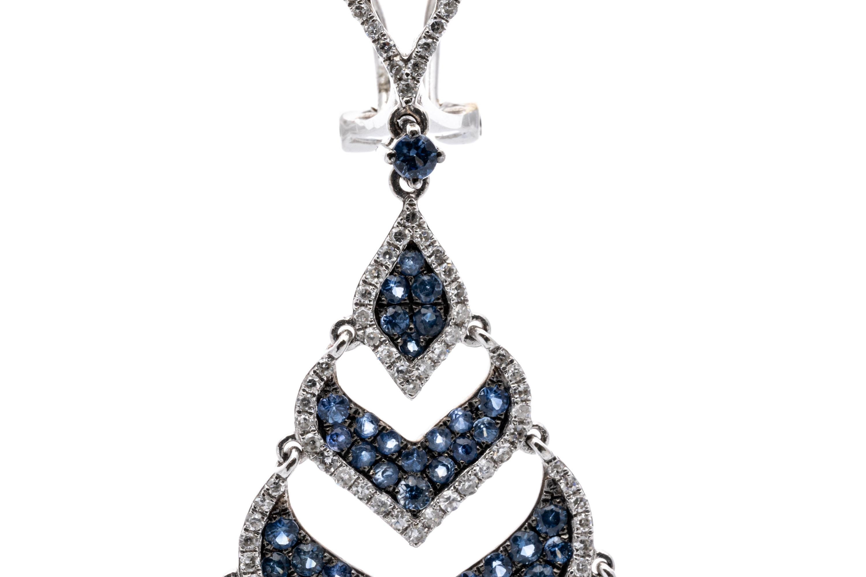 18k Gorgeous Blue Sapphire (3.98 TCW) And Diamond (1.24 TCW)  Pendant Earrings. These graceful, gorgeous earrings contain four nesting, graduated, chevron shaped drop swirls, all set with pave set round faceted light blue sapphires, trimmed with an